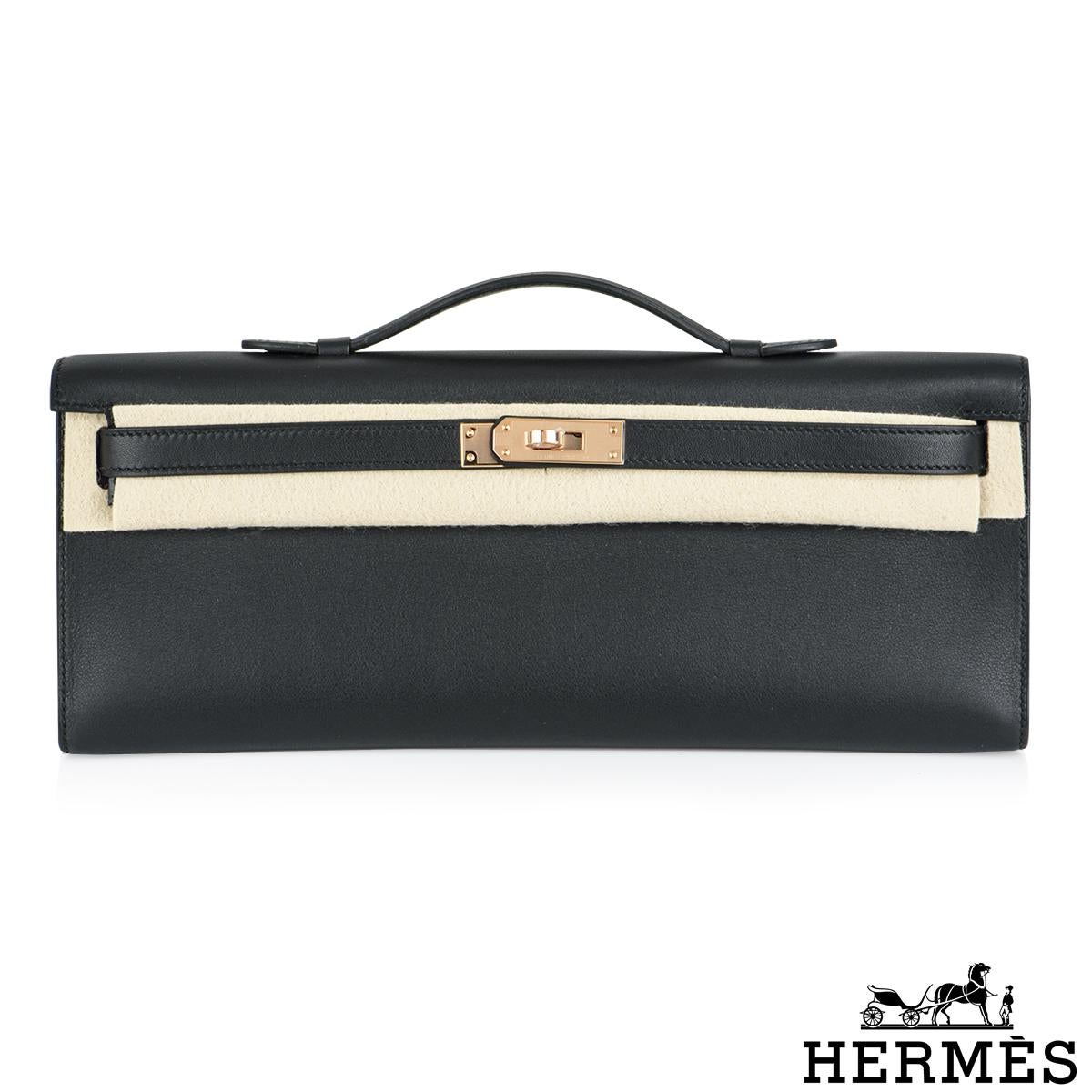A chic Black Hermes Kelly Cut Clutch with rare Rose Gold Hardware. The exterior of this Kelly Cut features black veau swift leather with tonal stitching. It is complemented with rose gold tone hardware with front toggle closure and a top handle. The