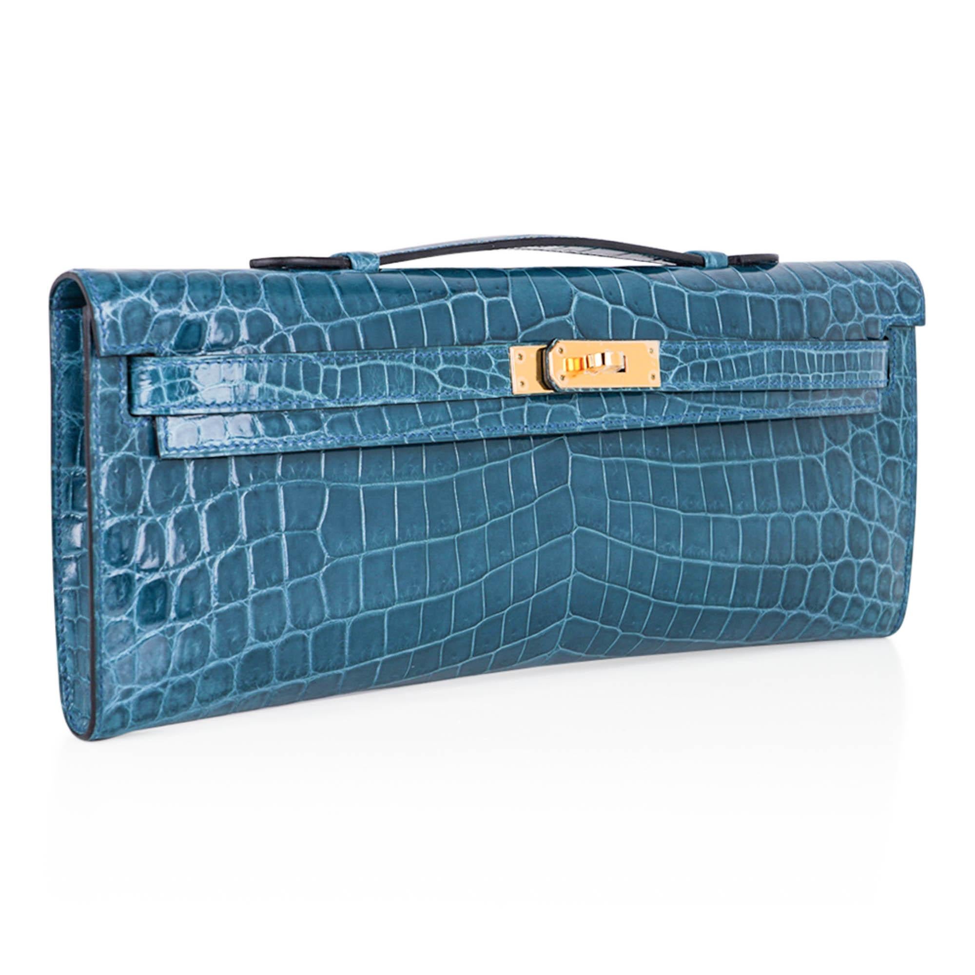 Mightychic offers a limited edition Hermes Kelly Cut featured in smoky Bleu Colvert Niloticus Crocodile.
Richly complimented with Gold hardware.
The perfect pop of soft colour for any outfit.   
Stamped HERMES MADE IN PARIS on the interior. 
Comes