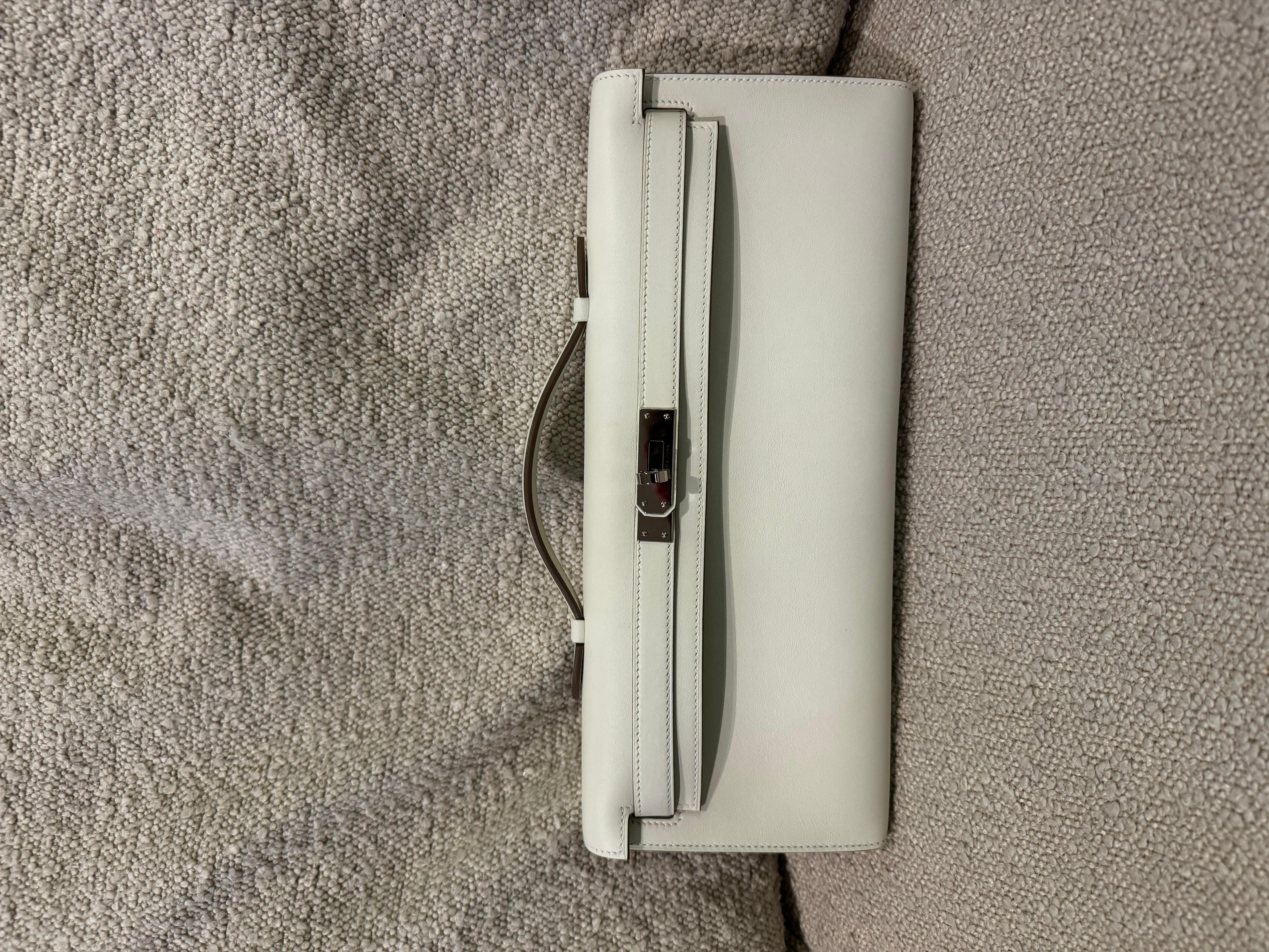 Hermes Kelly cut craie swift palladium hardware clutch bag. Comes with dustbag and box. The most classy and elegant day and night clutch. It can be carried via its top handles or worn under the arms. Purchased 2023.