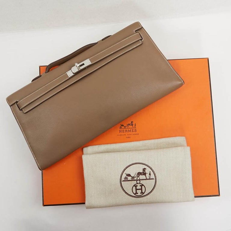 Hermes Kelly Cut  in swift leather and tow color. The hardware is palladium silver. 
The lining is made of lamb leather of the same color with a large zipped pocket.
It is in a very good condition. Micro scratches on the jewelry.
Letter K in a