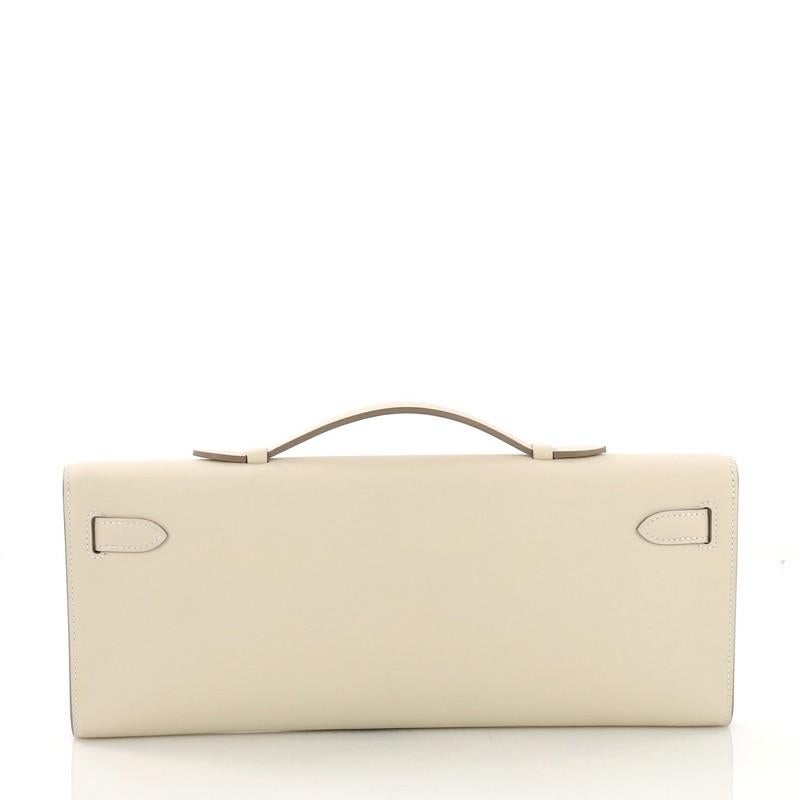 Beige Hermes Kelly Cut Pochette Swift, crafted in Craie cream Swift leather
