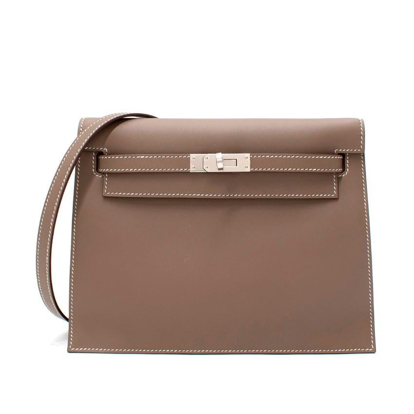 Hermes Kelly Danse Etoupe Swift Leather PHW
 

 - Age Z 2021
 - Classic Etoupe hue, rendered in smooth Swift leather
 - Warm grey-brown leather is offset by cool palladium hardware throughout
 - Classic Kelly belt and flap
 - Compact shape, perfect