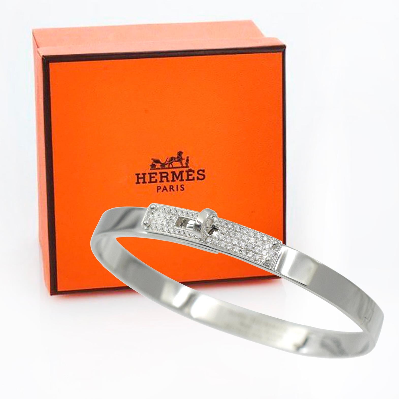 Hermes 18k white gold Kelly bangle bracelet. Small
model. This bangle is 5.5mm wide with high polish finish,
 accented with a Kelly lock encrusted with 61 round brilliant cut
diamonds Inscribed: Au750, Hermes, SH, Made in France, xxxxxxx,