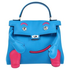 Petit sac à main Kelly Doll en cuir Swift bleu et rose avec poignée supérieure en palladium Hermès
