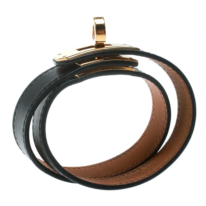 This Hermes Double Tour wrap bracelet is a chic accessory that can be paired with everything, from causals to evening outfits. Crafted from leather in a classic black shade, it is beautified with a Kelly twist closure in gold-plated metal. The