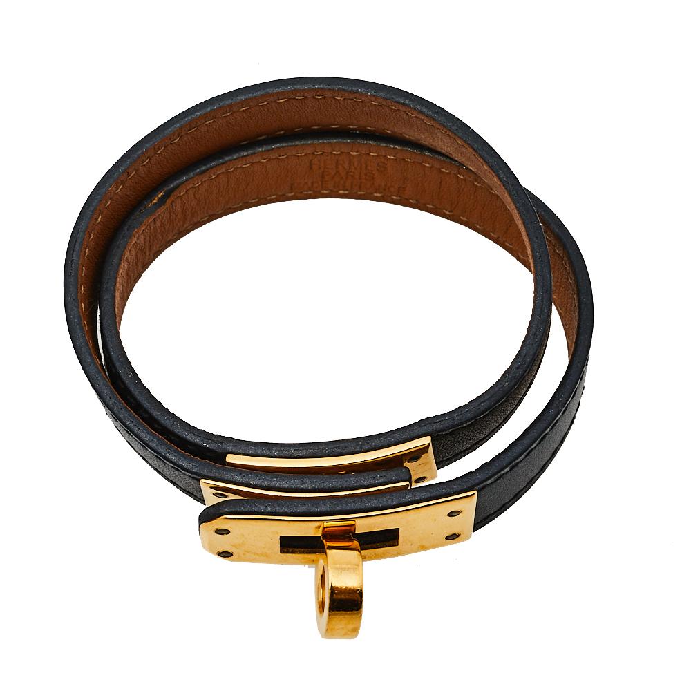 This Hermes Double Tour wrap bracelet is a chic accessory that can be paired with everything, from causals to evening outfits. Crafted from leather in a classic black shade, it is beautified with a Kelly twist closure in gold-plated metal. The