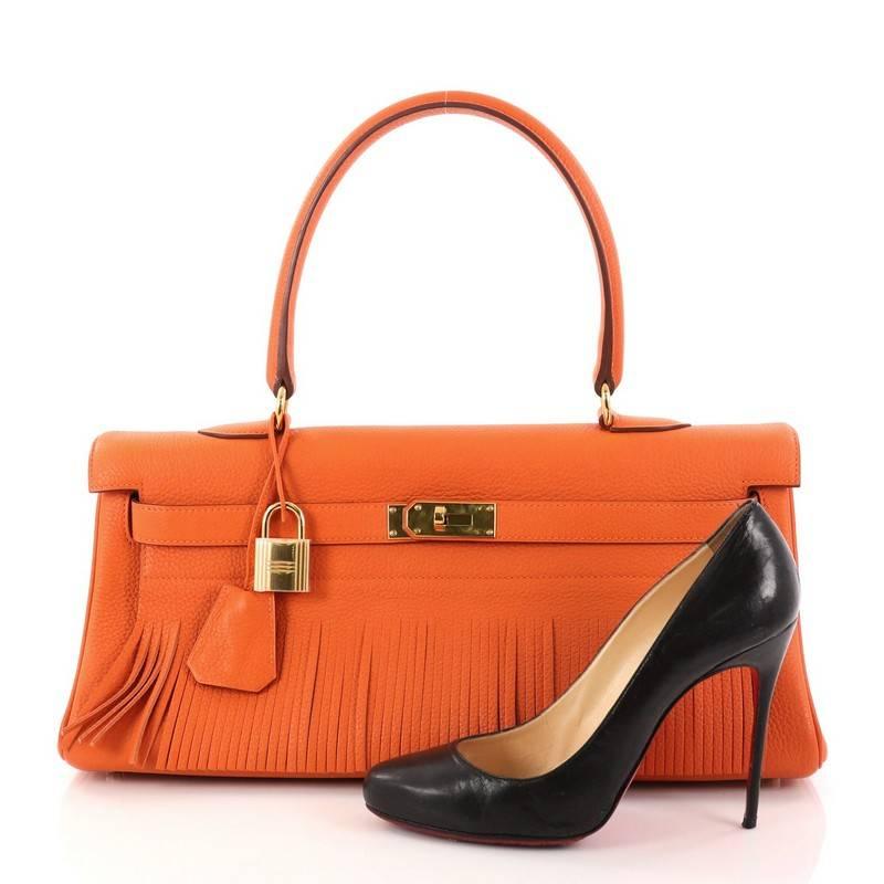This authentic Hermes Kelly Fringe Shoulder Bag Clemence 42 is a rare collector's item made for any Hermes lover. Exquisitely created by designer Jean Paul Gaultier in iconic orange clemence leather, this avant-garde version of the classic Kelly