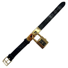 Montre Hermes Kelly Cadena Lock en or avec bracelet en cuir Mysore Chèvre noir 1990