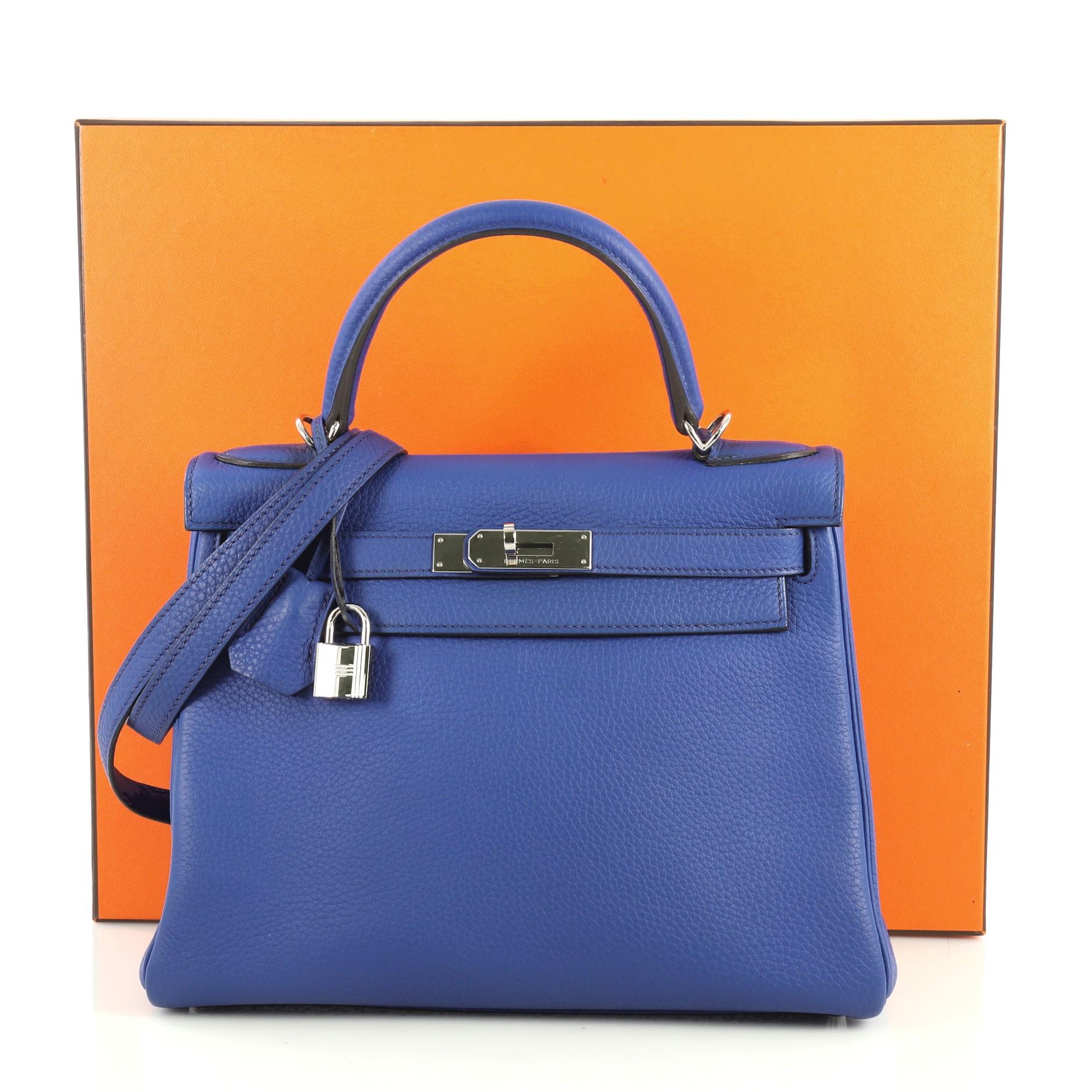 This Hermes Kelly Handbag Bleu Electrique Clemence with Palladium Hardware 28, crafted in Bleu Electrique blue Clemence leather, features a single rolled top handle, protective base studs, and palladium hardware. Its turn-lock closure opens to a