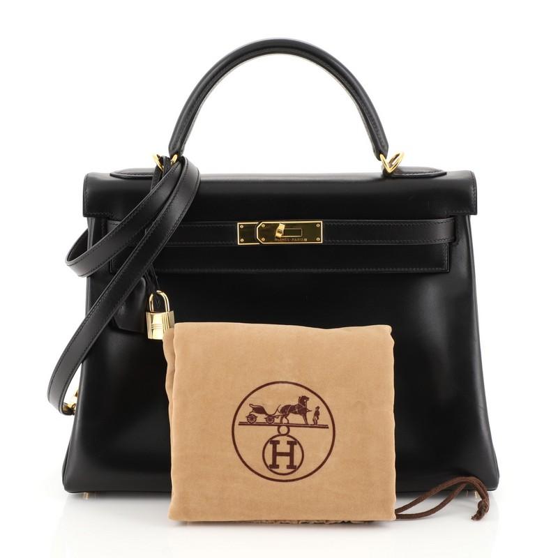 This Hermes Kelly Handbag Noir Box Calf with Gold Hardware 32, crafted in Noir black Box Calf leather, features a single rolled top handle, protective base studs, and gold hardware. Its turn-lock closure opens to a Noir black Chevre leather interior