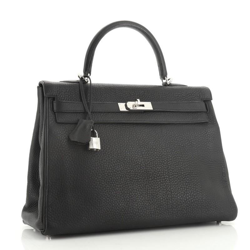 This Hermes Kelly Handbag Noir Clemence with Palladium Hardware 35 is truly a classic piece. Known for their expert craftsmanship, each bag takes over 18 hours to produce. Crafted from Noir black Clemence leather, this handbag features a single top