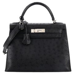 Hermès Sac à main Kelly en autruche noire avec accessoires en palladium, Taille 25