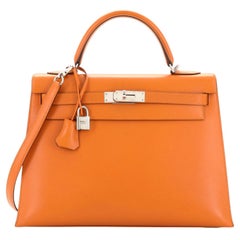 Hermès - Sac à main Kelly en veau orange avec finitions métalliques en palladium 32