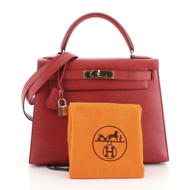 This Hermes Kelly Handbag Rouge Vif Courchevel with Gold Hardware 28 is truly a classic piece. Known for their expert craftsmanship, each bag takes over 18 hours to produce. Crafted from Rouge Vif red Courchevel leather, this handbag features a