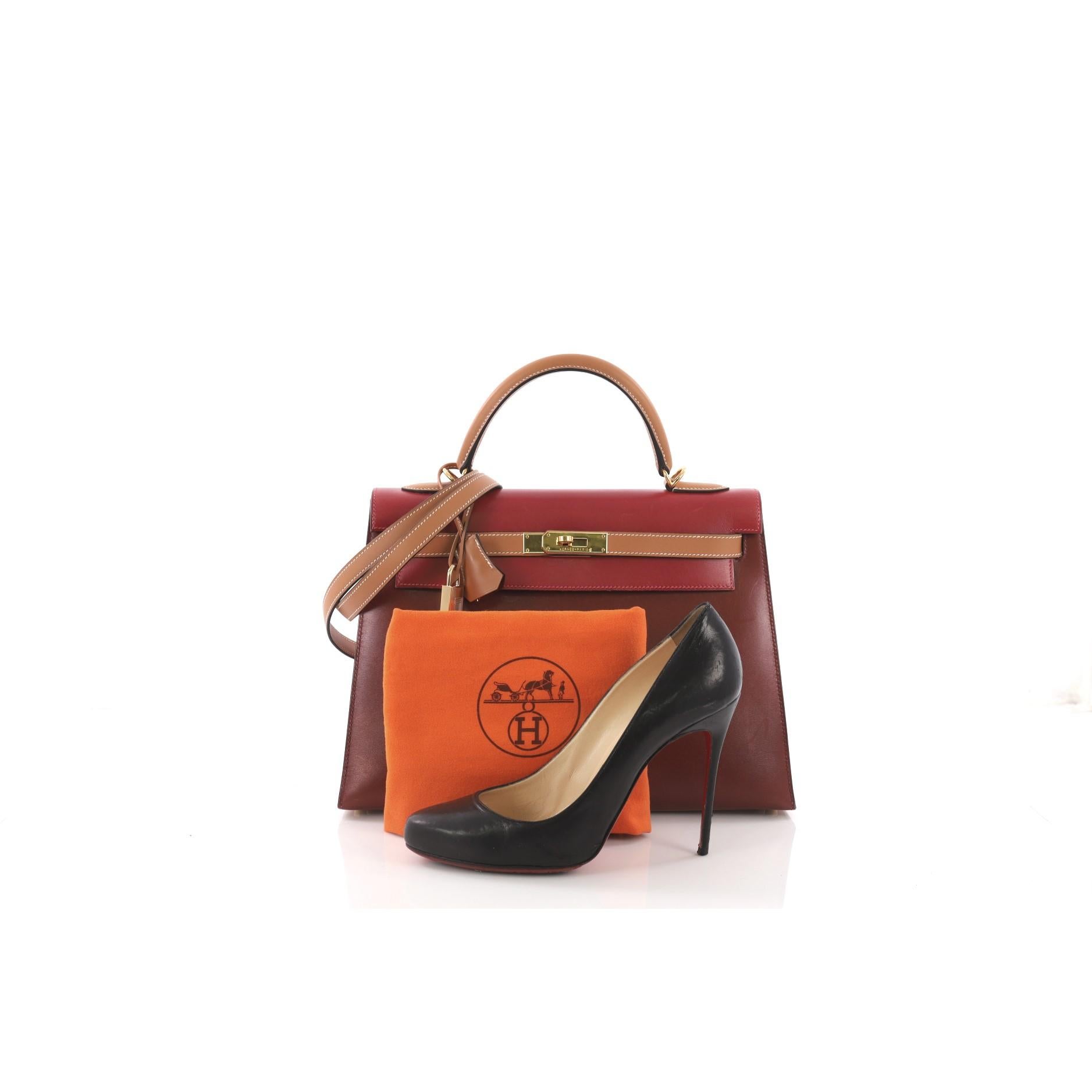 This Hermes Kelly Handbag Tricolor Box with Gold Hardware 32, crafted in Rouge H, Natural, and Rouge Vif Box Calf & Chamonix leather, features a single rolled leather handle, a frontal flap, and gold-tone hardware. Its turn-lock closure opens to a