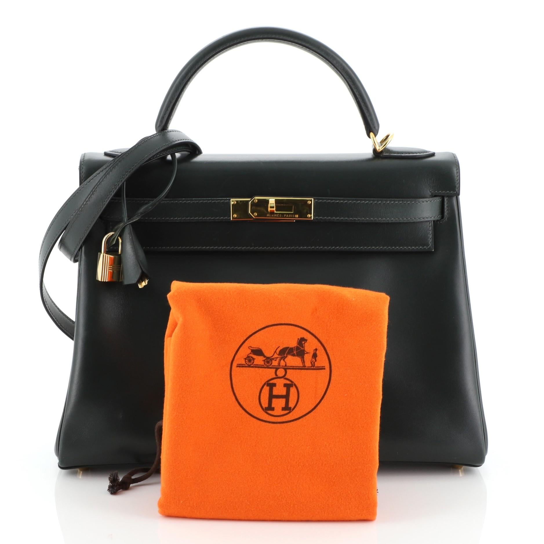 This Hermes Kelly Handbag Vert Fonce Box Calf with Gold Hardware 32, crafted in Vert Fonce green Box Calf leather, features single top handle, protective base studs, and gold hardware. Its turn-lock closure opens to a Vert Fonce green Chevre leather
