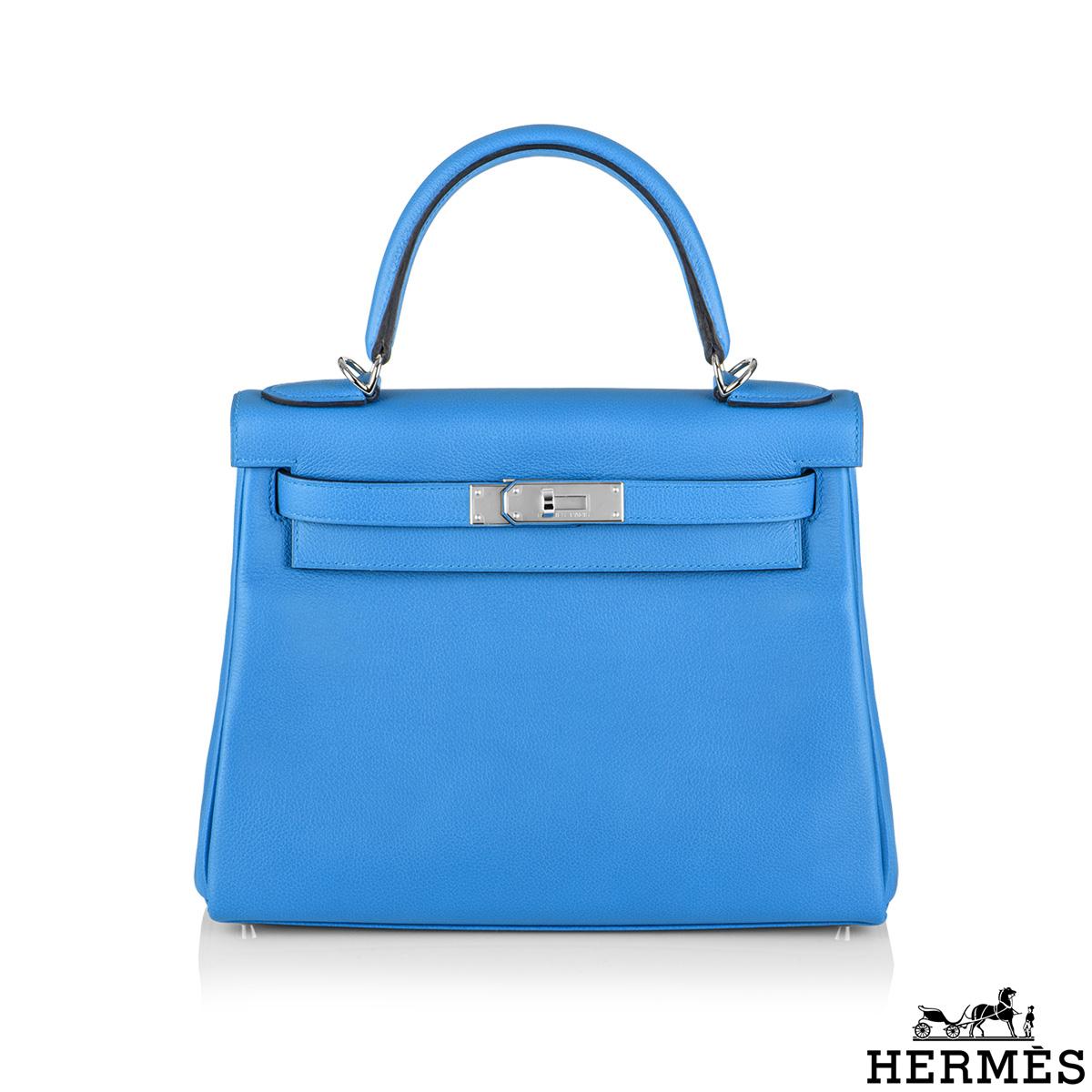 An exquisite Hermès Kelly II Bleu Frida Retourne 28cm Handbag. The vivid blue evercolour calfskin leather bag is detailed with palladium hardware. The exterior of this Kelly features a Retourne style in blue calfskin leather. It has a front toggle