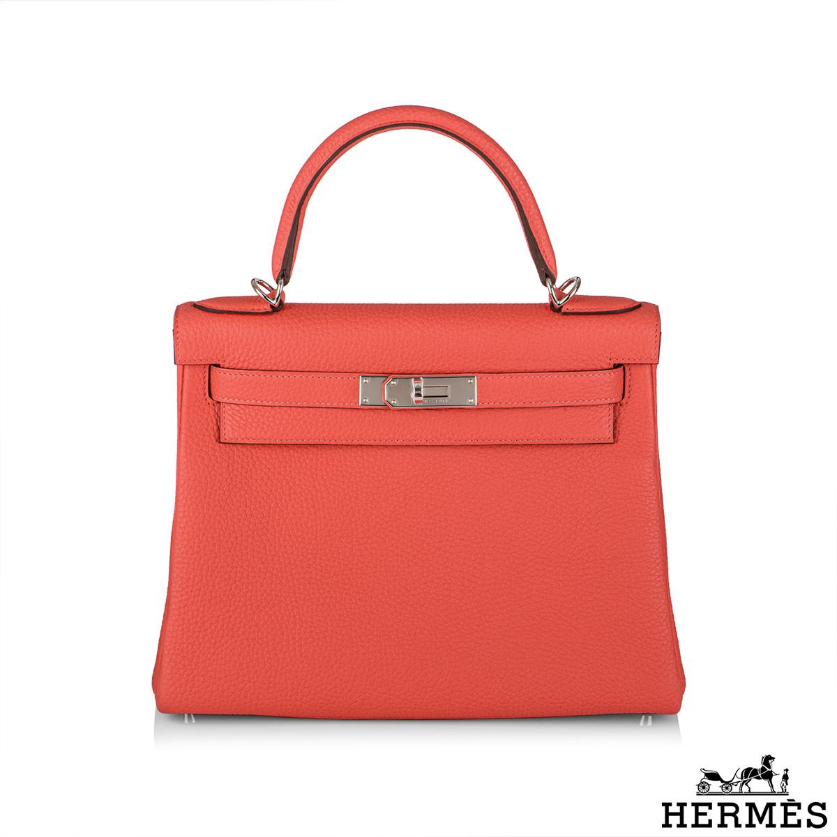 An exquisite Hermès Kelly II Rose Texas Retourne 28cm Handbag. The vivid Rose texas clemence leather bag is detailed with palladium hardware. The exterior of this Kelly features a Retourne style in clemence leather. It has a front toggle closure, a