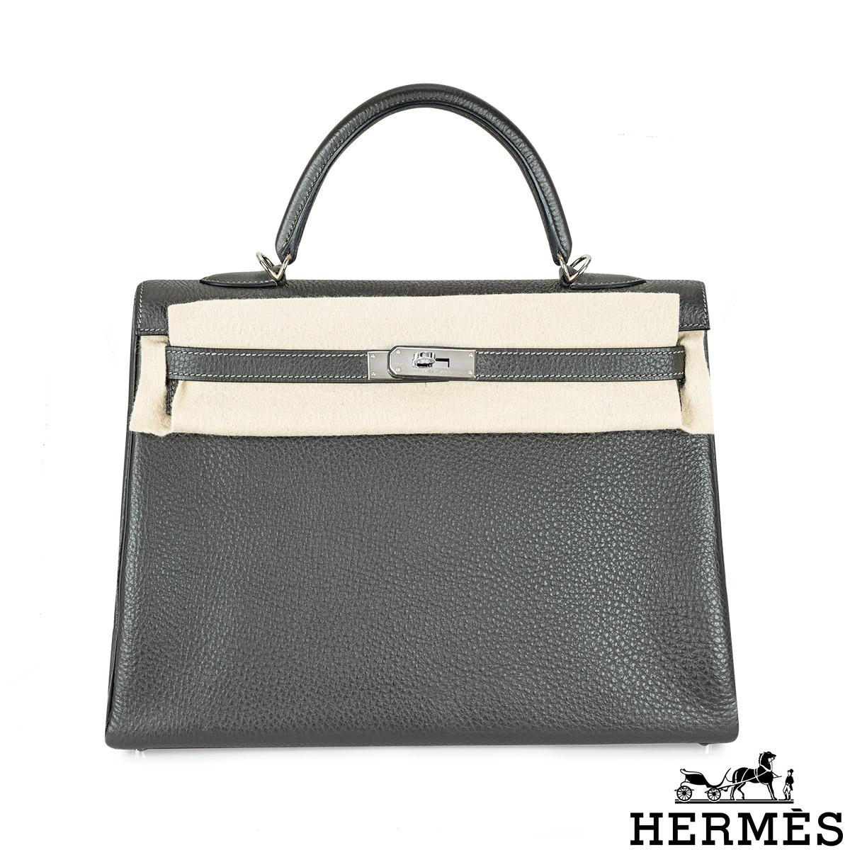A lovely Hermès Kelly II Retourne 35cm bag. The exterior of this Kelly is crafted in Graphite Veau Taurillon Clemence leather and is detailed with palladium hardware. It features a front toggle closure, a single rolled top handle and tonal