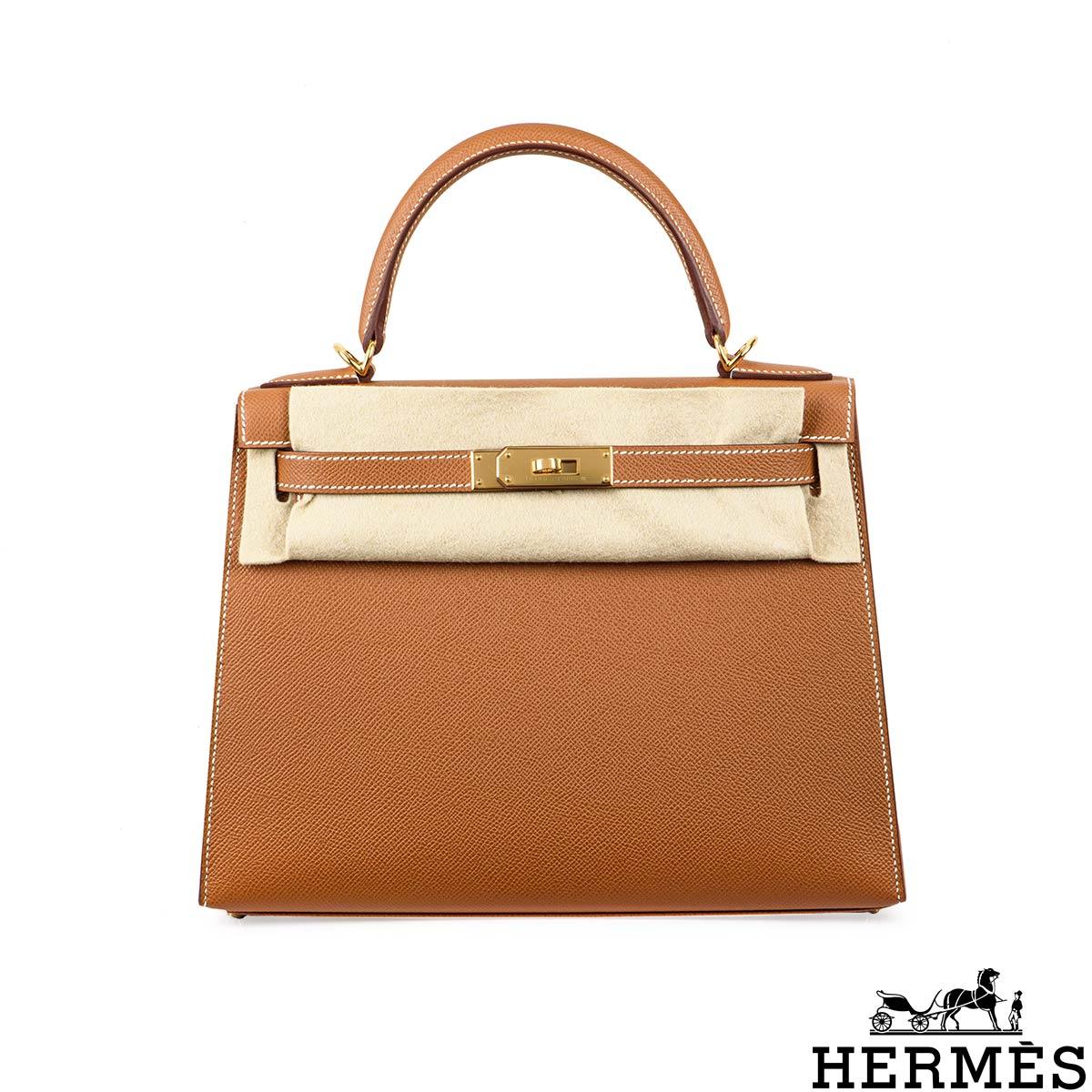 A classic Hermès Kelly II Sellier 28cm handbag. The exterior of this Kelly features the Sellier style in Gold Epsom leather and is complemented by gold tone hardware and white stitchings. It has a front toggle closure with two straps, a single