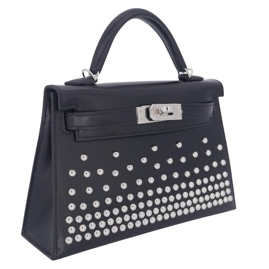 Brand: Hermès
Style: Kelly II Sellier Mini Cloute
Size: 20cm
Color: Black
Material: Box Calf Studded Leather
Hardware: Palladium Hardware (PHW)
Dimensions: 7.5