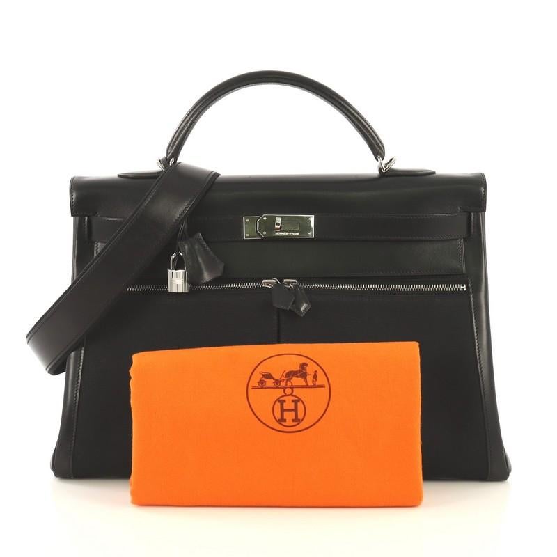 This Hermes Kelly Lakis Handbag Toile and Noir Box Calf with Palladium Hardware 40, crafted from Noir black Box Calf leather and Toile Officier, features a rolled top handle, exterior front zip compartments, exterior back zip pocket, and palladium