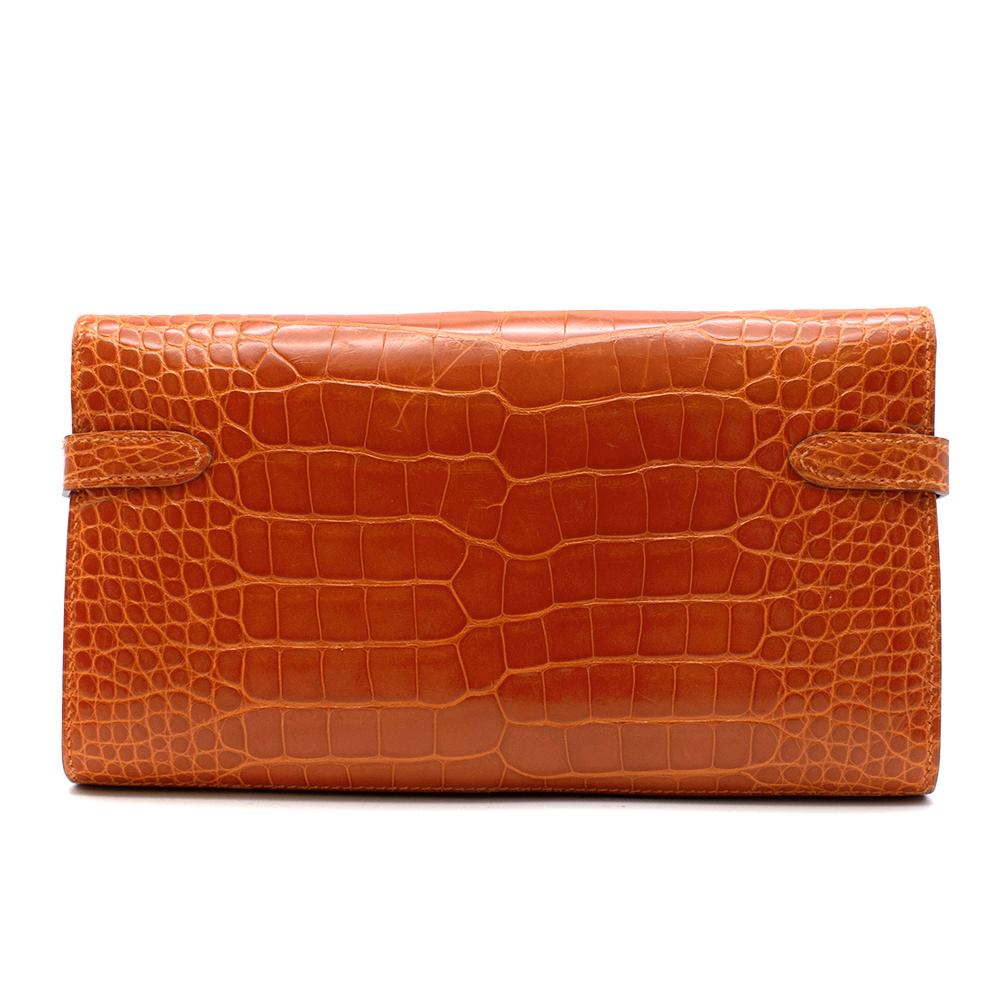 Hermès Kelly Long Wallet in Feu Lisse Alligator Mississippiensis with Palladium Hardware. 
2014

Includes Dust Bag. 
Size: Long

11.5 x 19.7 cm

Please note this does not have CITES