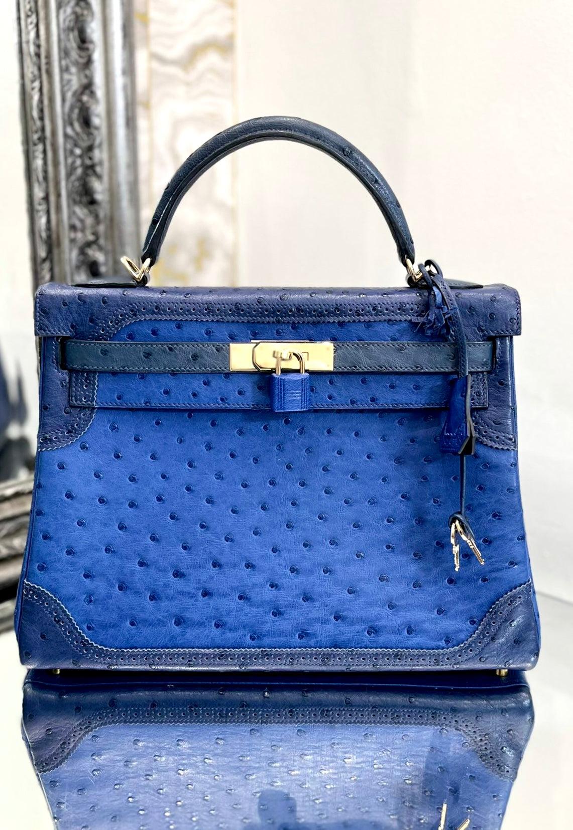 ﻿Hermes Kelly Ltd Edition Ghillies Bag In Ostrich Skin 

Very rare bag, in blue sapphire, blue malte, and blue iris with 

gold hardware. Keys, clochette and removable shoulder strap.

Date stamp 2014.

Some of the protective covers are still on the