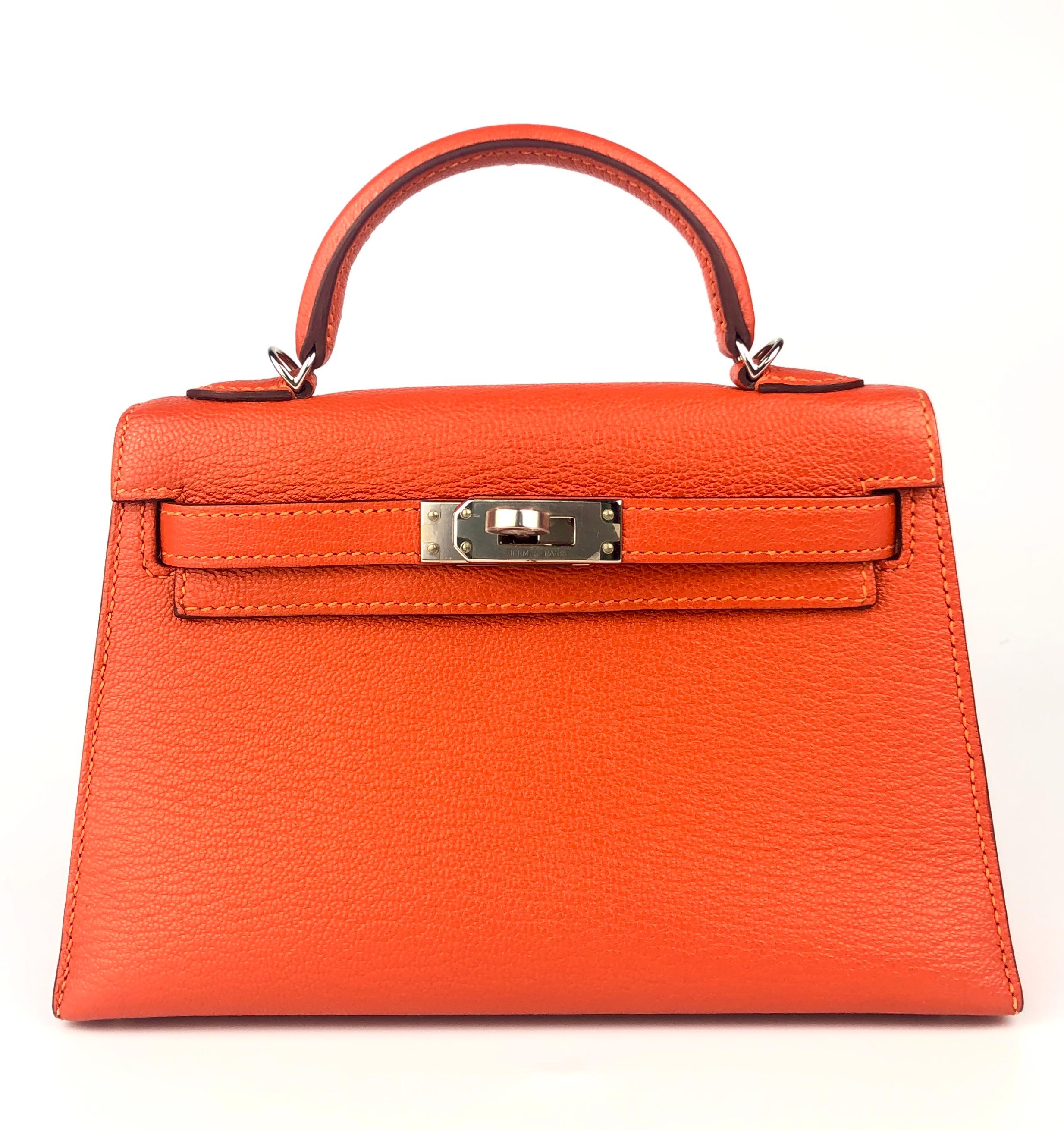 As New Ultra Rare and Hardest to get Hermes Mini Kelly 20 Verso Feu Orange Chèvre Leather Rose Eglantine Interior  Complimented by Palladium Hardware. D Stamp 2019. Includes all Accessories and Box.

Shop with Confidence from Lux Addicts. We are a