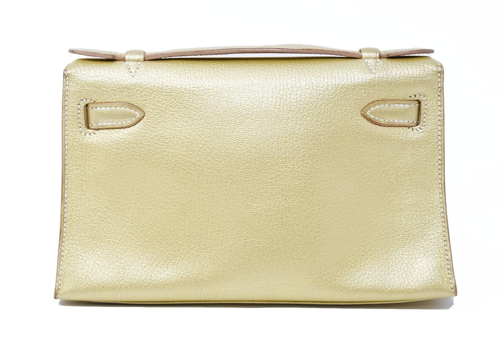 Extremely Rare and coveted Hermes Kelly Pouchette in gold leather with Palladium Hardware.  New and never been used. In pristine condition, this bag comes with box and dustcover.  