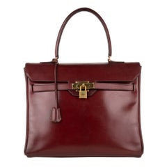 Hermès Kelly "Monaco"30 handbag in burgundy calfskin leather and golden hardware