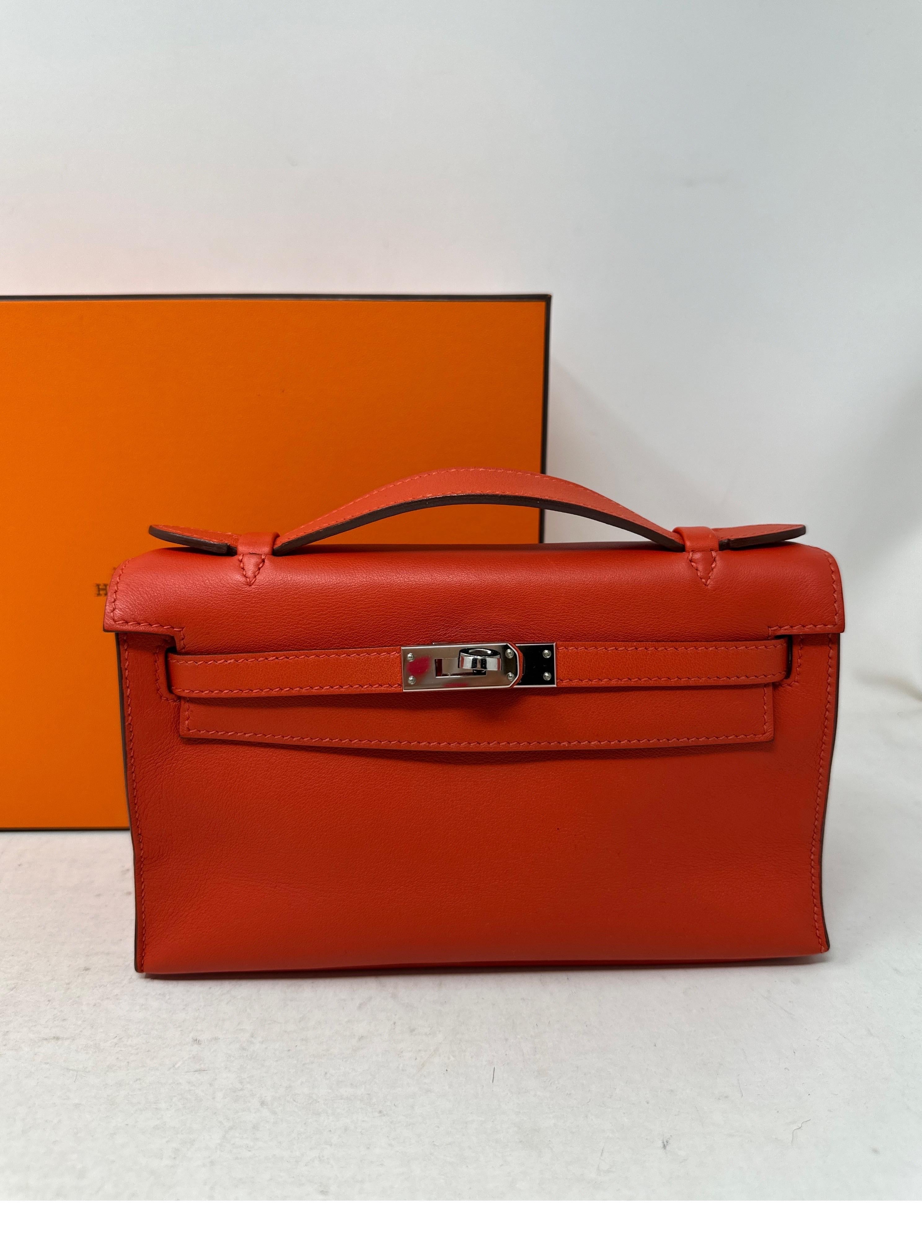 Hermes Orange Kelly Pochette. Palladium silver hardware. Swift leather. Rare pochette bag. Excellent condition. Interior clean. Great investment bag. Don't miss out. 