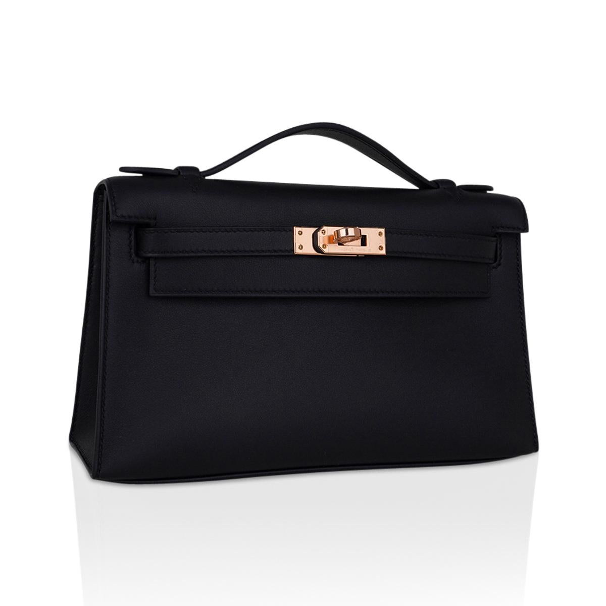 Mightychic offers an Hermes Kelly pochette bag featured in sleek Black Swift leather.
This beautiful Hermes clutch is accentuated with warm Rose Gold hardware.
Signature stamp on interior.
Small interior compartment.
Comes with signature Hermes box
