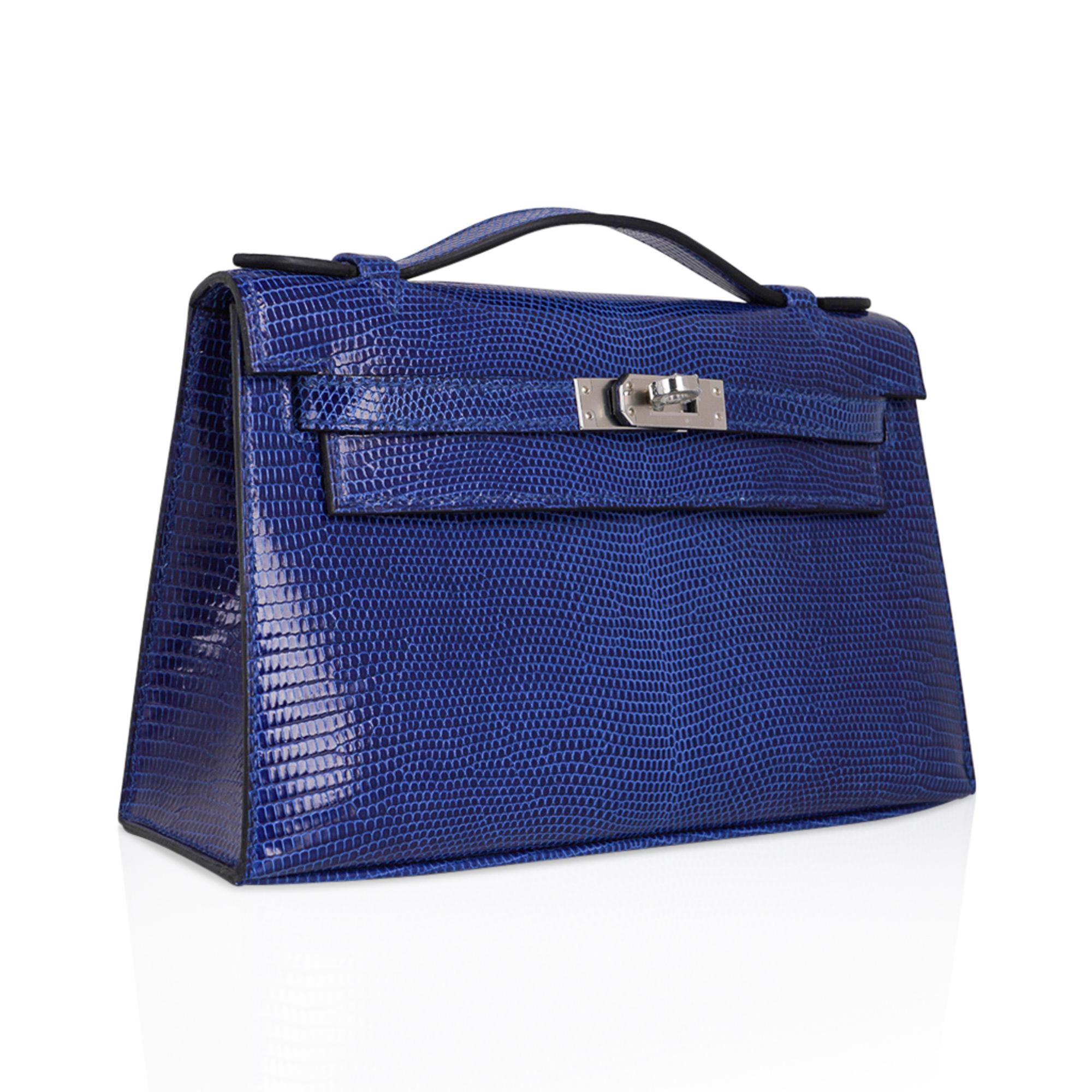 Mightychic offers an Hermes Kelly pochette bag featured in Bleu Saphir Lizard.
This beautiful jewel toned Hermes clutch is fresh with Palladium hardware.
Richly saturated this is a magnificent neutral bag that adds a pop a colour.
Signature stamp on
