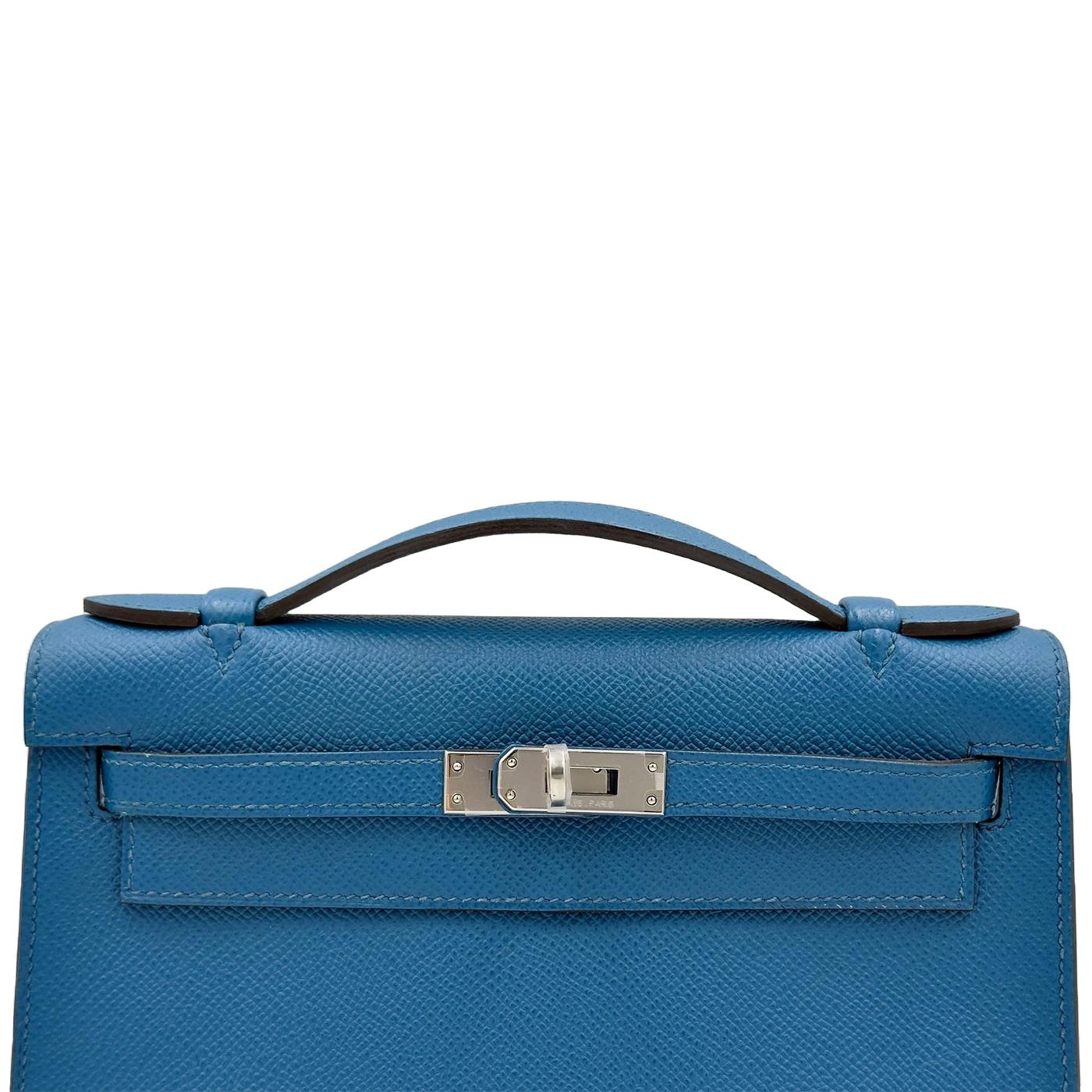This is an authentic HERMES Epsom Kelly Pochette Clutch in Bleu Izmir. This chic clutch is crafted of Epsom calfskin leather in blue. The bag features a leather top handle a flap and a strap closure with a palladium turn-lock. This opens to a
