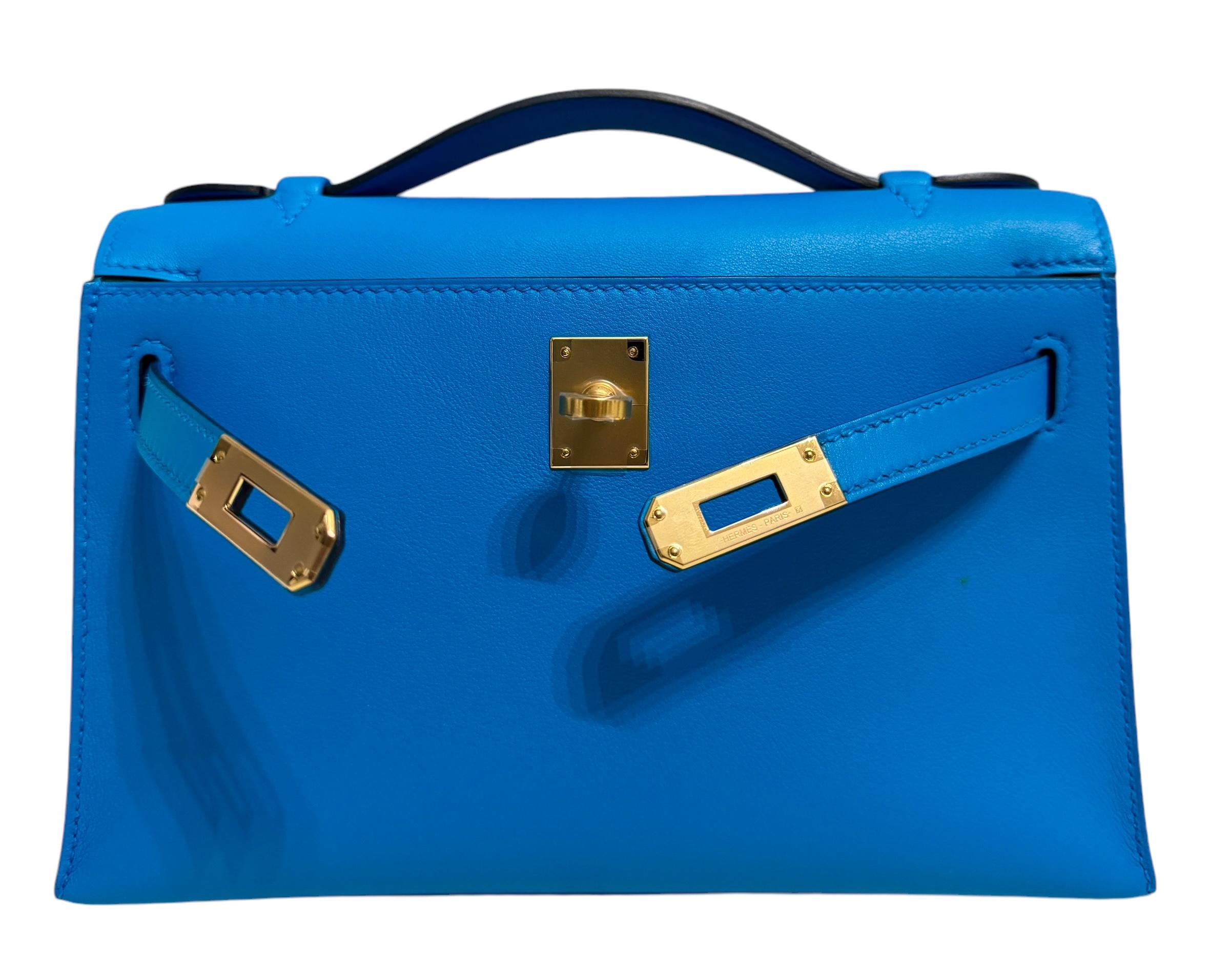 Ultra Rare and Hardest to get Hermes Mini Kelly Pochette Blue Frida Swift Leather Complimented by Gold Hardware.  As New Plastic on all Hardware. Y Stamp 2020. From Collectors closet. 

Shop with Confidence from Lux Addicts. We are a very well known