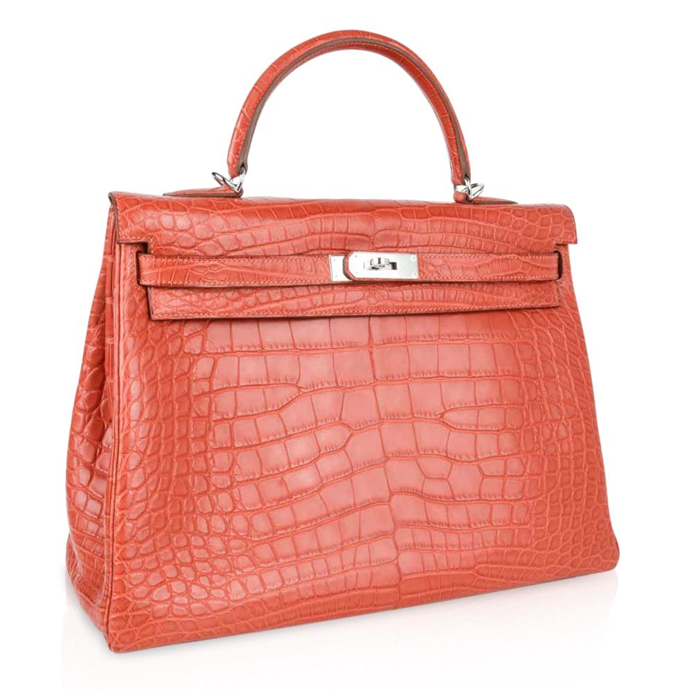 Mightychic offers an Hermes Retourne 35 Kelly bag featured in Sanguine Matte Alligator.   
Warm clay red with orange undertone makes this a fabulous neural year round Hermes Kelly bag.
Fresh palladium hardware.   
Comes with shoulder strap, lock,