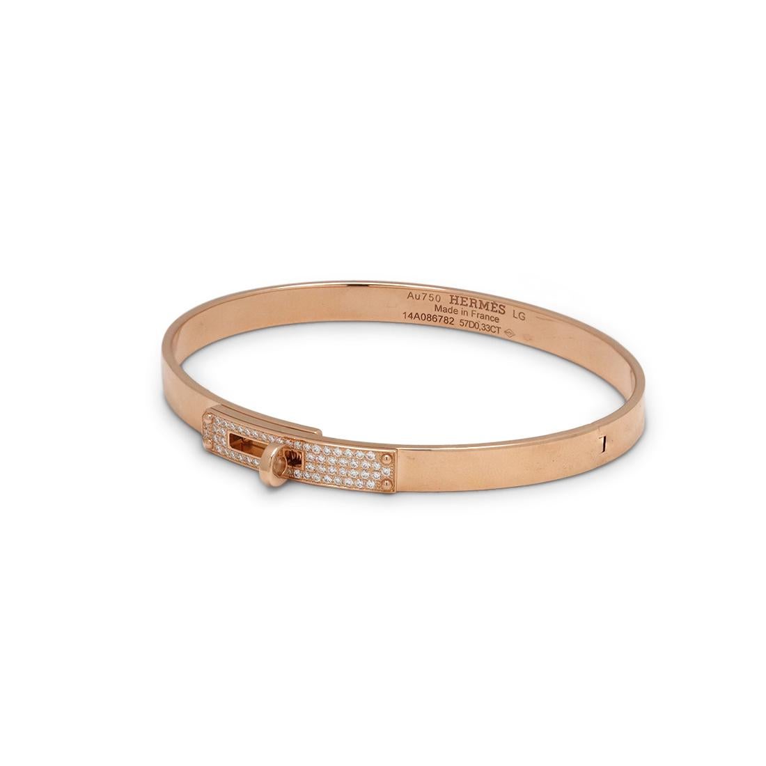 Authentic Hermès 'Kelly' bracelet crafted in 18 karat rose gold and accented with round brilliant cut diamonds weighing approximately 0.33 carats. It's fastener, a turn clasp, is synonymous with the brand. Signed Hermes Paris, Au750, Made in France,