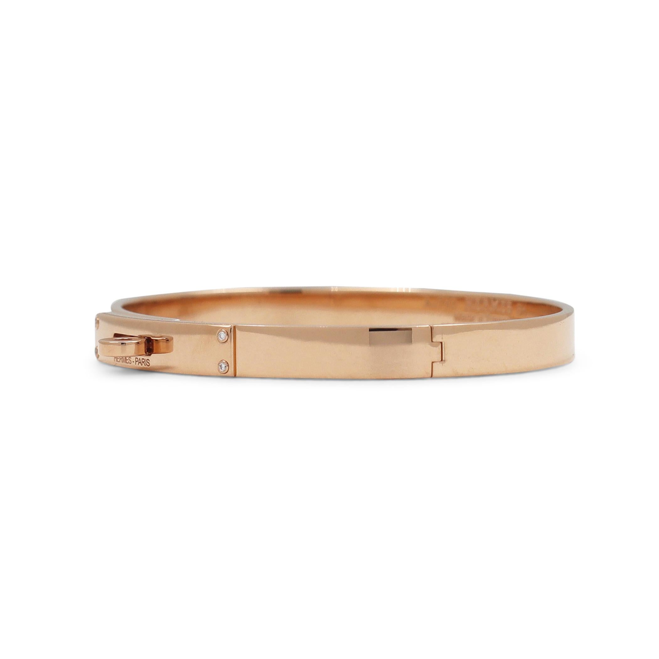 Authentic Hermès 'Kelly' bracelet crafted in 18 karat rose gold and accented with 4 round brilliant cut diamonds weighing an estimated 0.02 carats total. Its fastener, a turn clasp, is synonymous with the brand. Signed Hermes Paris, Au750, Made in