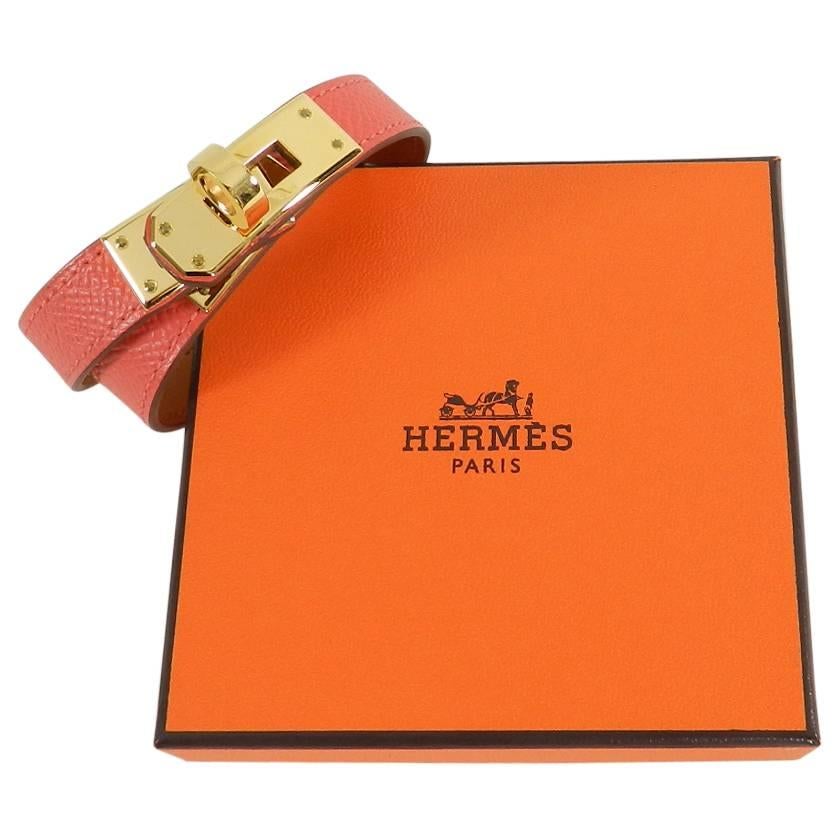 Hermes Kelly Double Tour Bracelet in Rose Jaipur.  Hot coral pink double wrap bracelet with gold plated hardware.  Includes pouch and box.  Size M (17.7 cm circumference). Date code T for production year 2015. Excellent pre-owned condition. Only