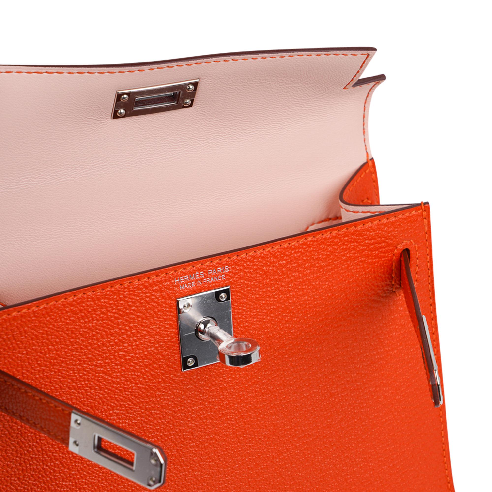 Mightychic offers an Hermes Kelly 20 Mini Sellier bag featured in vibrant orange Feu with gentle pink Rose Eglantine interior. 
Coveted Chevre leather accentuated with Palladium hardware.
Comes with signature Hermes box, shoulder strap, and