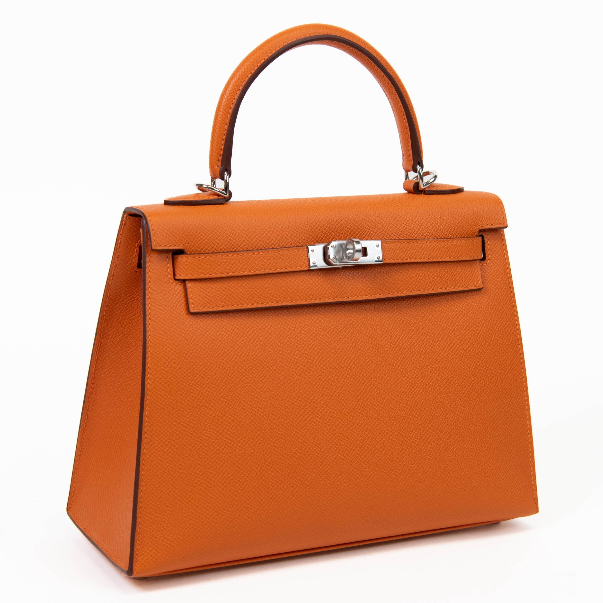 

100% Authentic

This Kelly, in the Sellier style, is in Orange Epsom leather with palladium hardware and has tonal stitching, two straps with front toggle closure, clochette with lock and two keys, single rolled handle and removable shoulder