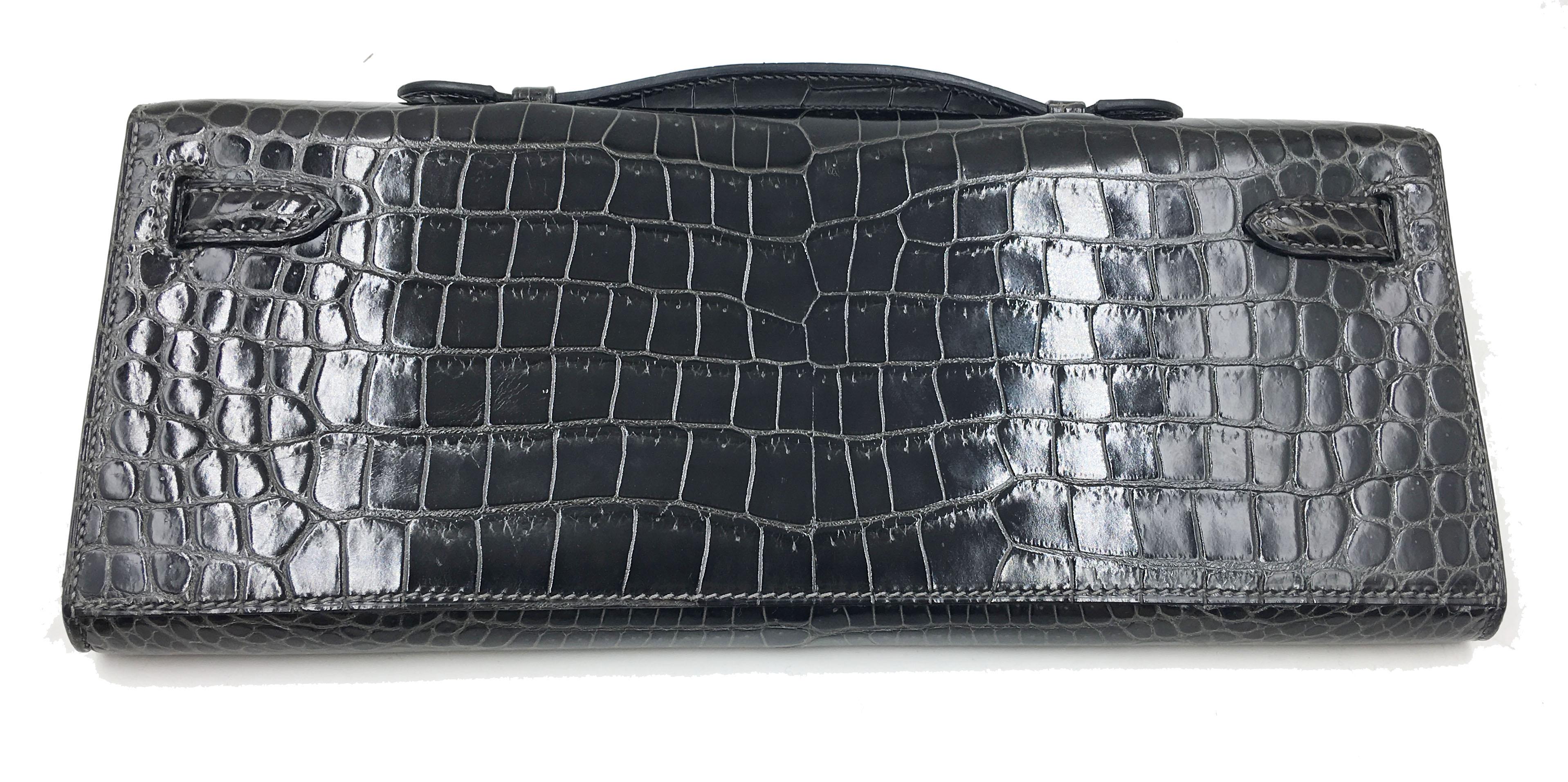 Hermes Kelly Shiny Black Porosus Crocodile Clutch with Diamonds.
Guaranteed authentic timeless very rare diamond Hermes Kelly Cut in rich jewel toned
Exquisite piece with Hermes set diamonds.

Collection M
Size: approximately 12.25
