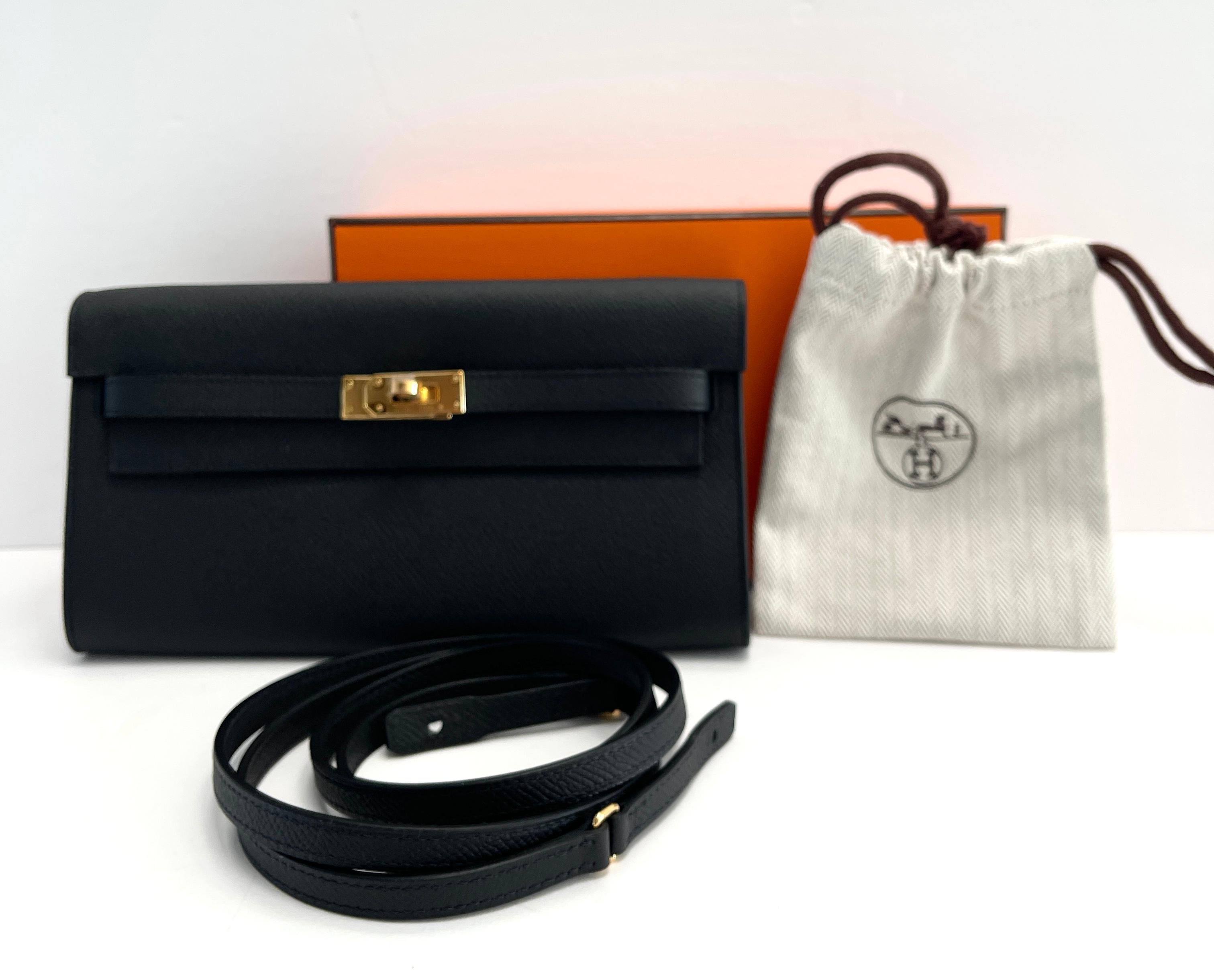 Hermes
Kelly to Go
Black

Such a versatile little Bag
Use as a clutch for evening
or with strap for day




Tonal topstich 
Epsom Leather
Gold Hardware

Removable strap
 To attach it to the wallet interior, you slide the strap through the two loops
