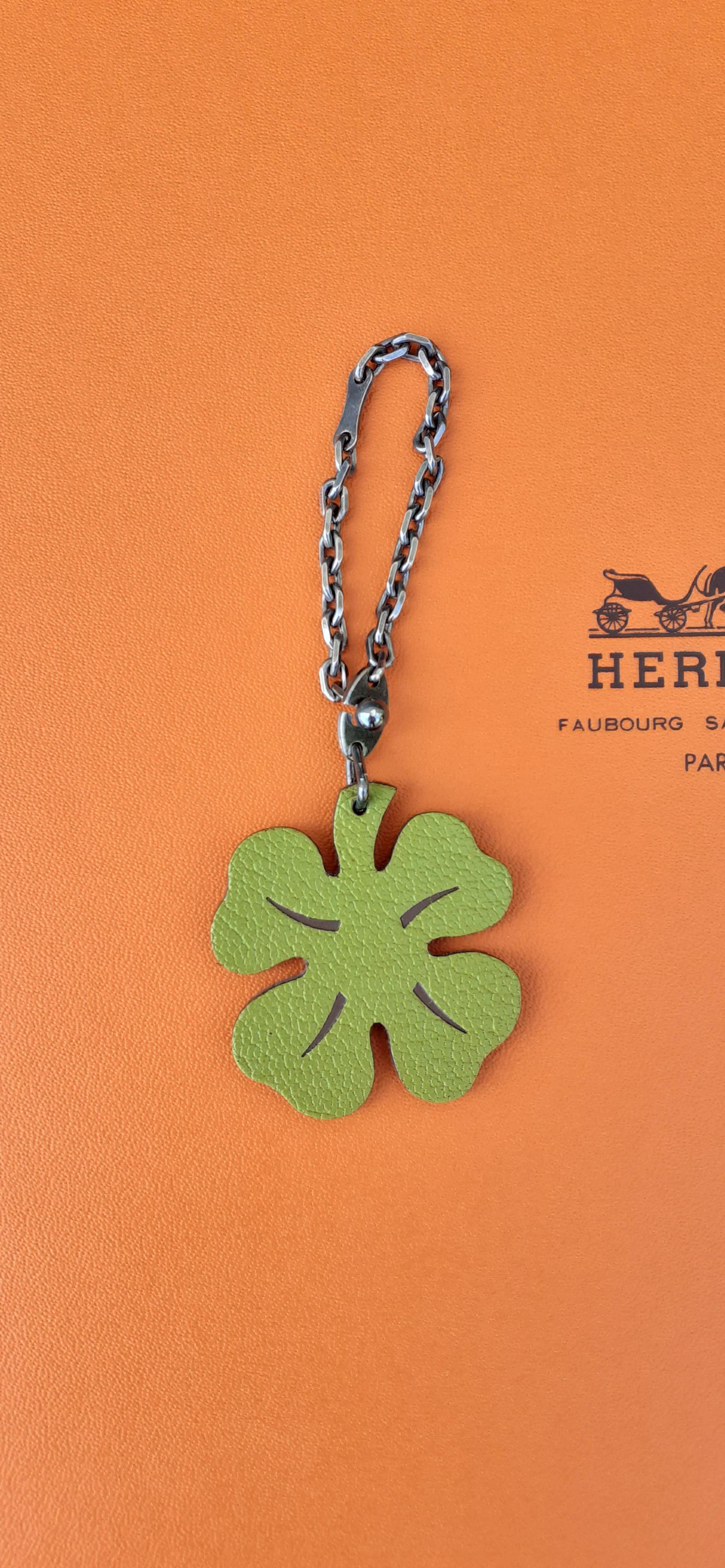 Super Cute Authentic Hermès Key Holder

Can be used as Bag Charm for your Kelly, Birkin or other Hermès Bag

Pattern: 4-leaf Clover

Made of Grained Leather

Colorway: 1 side Green and Brown, Other side Plain Orange

