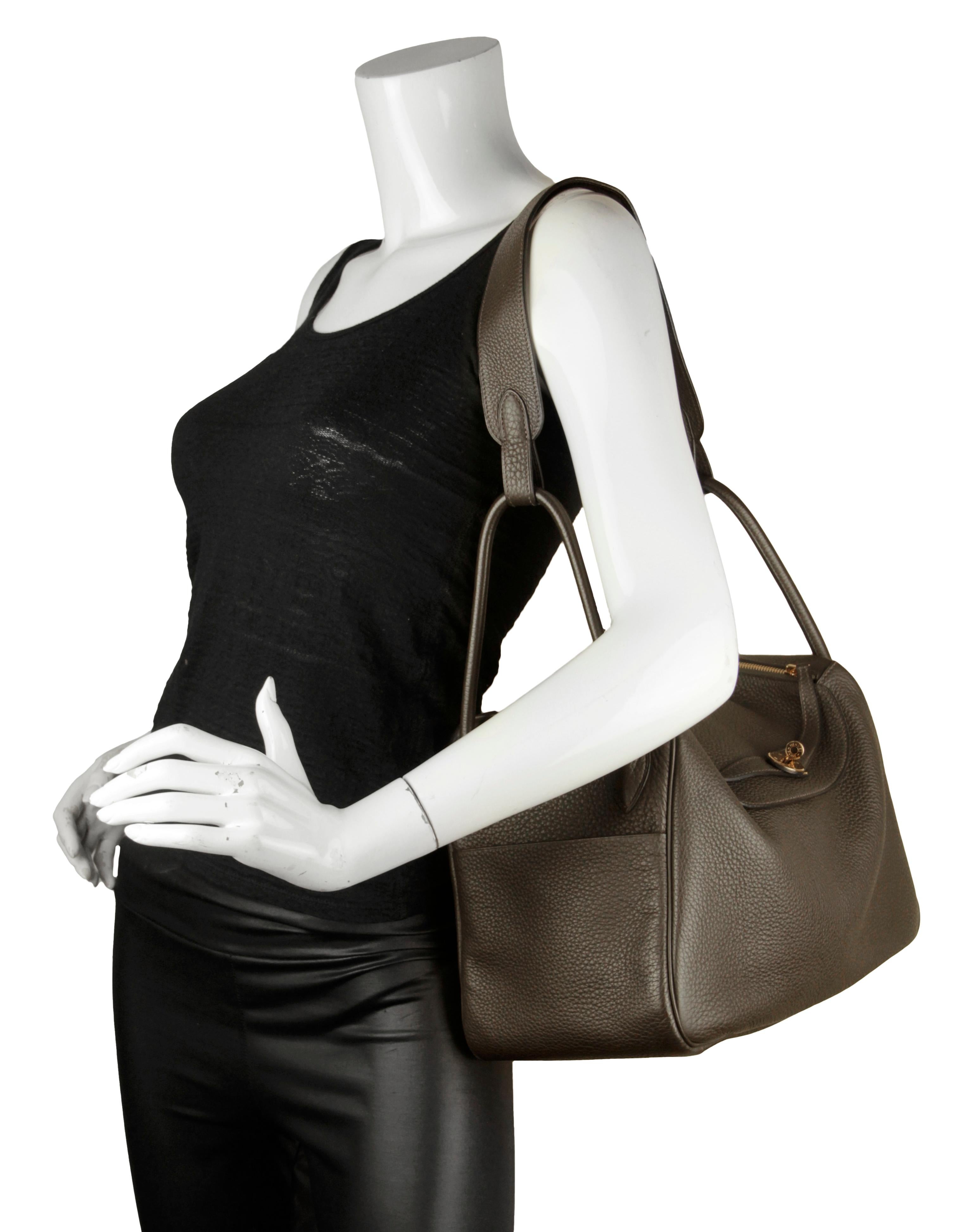 Hermes Khaki Taurillon Clemence Leather 34cm Lindy Shoulder Bag

Made In: France
Year of Production: 2009
Color: Khaki
Hardware: Goldtone palladium
Materials: Clemence leather
Lining: Leather
Closure/Opening: Double zipper with leather