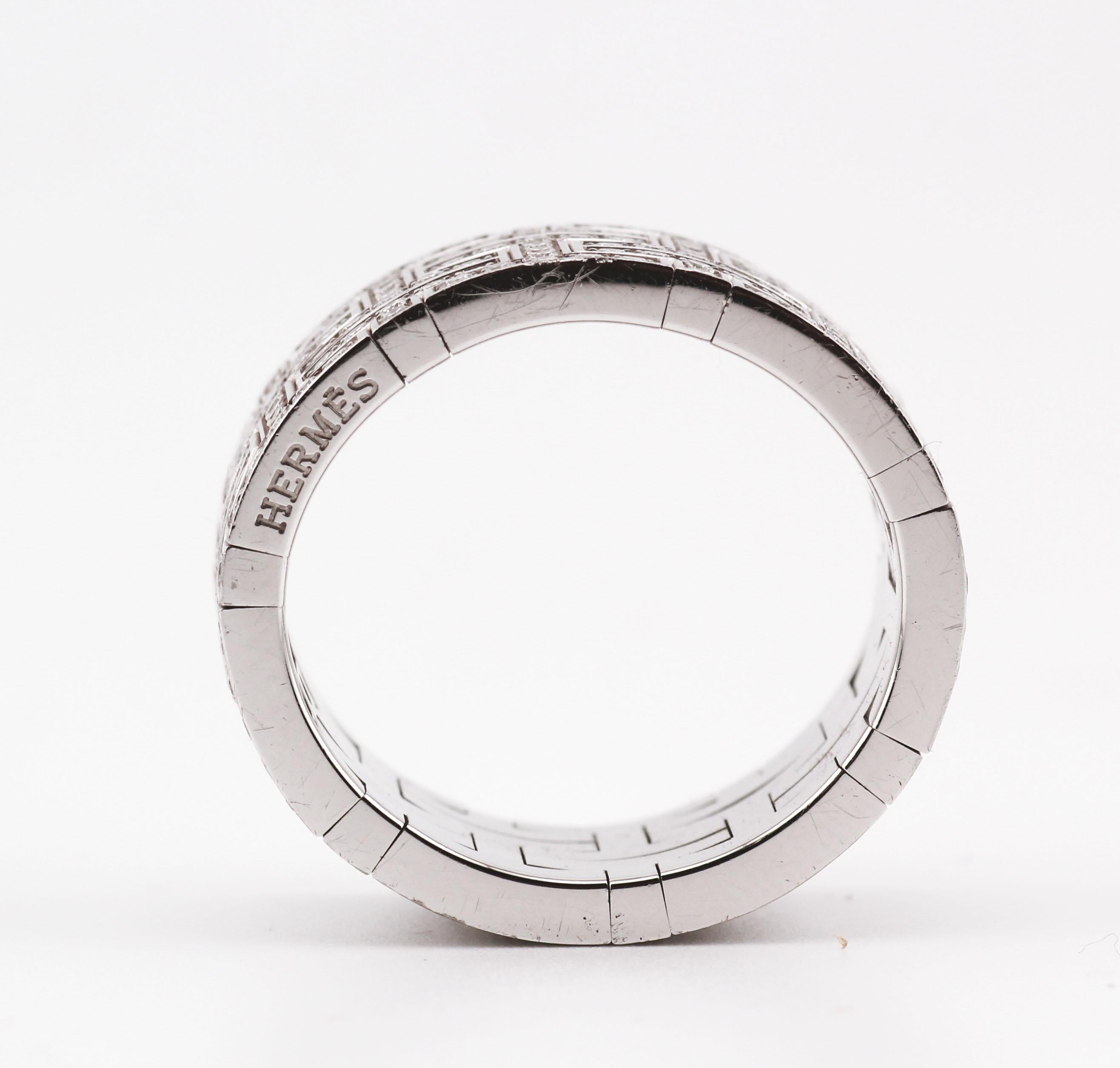 The Hermès band ring is a masterpiece of luxury and precision. Crafted from 18k white gold, it embodies a sleek and contemporary elegance. The design showcases a wide band that commands attention with its bold presence.

Intricately set diamonds