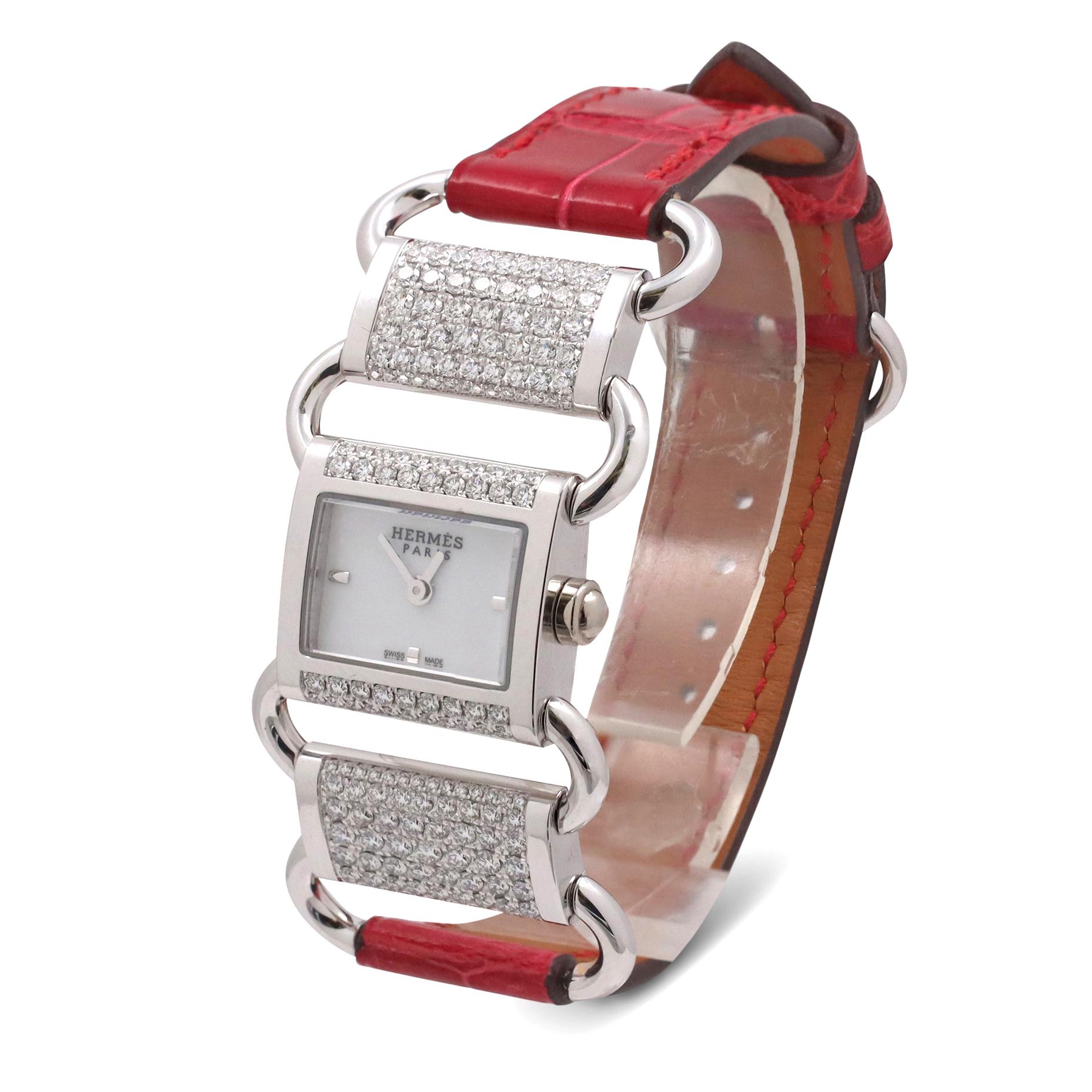 Authentic Hermès 'Klikti' ladies watch crafted in 18 karat white gold. The rectangular case measures 17mm x 16mm and the bezel and 2 adjoining links are set with round brilliant cut diamonds with approximately 2.9 carats total weight. Swiss quartz