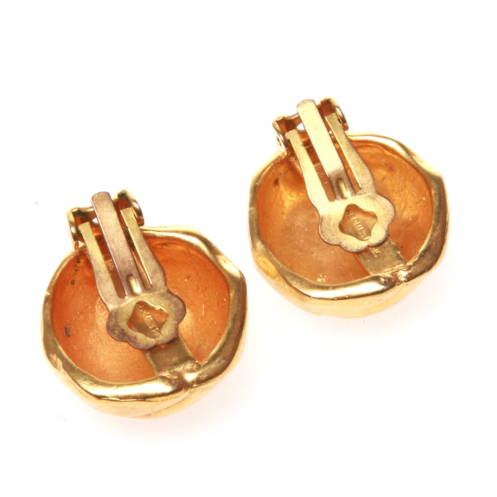 Vintage Hermes clip-on earrings featuring knotted leather button look design in gold-tone metal.  