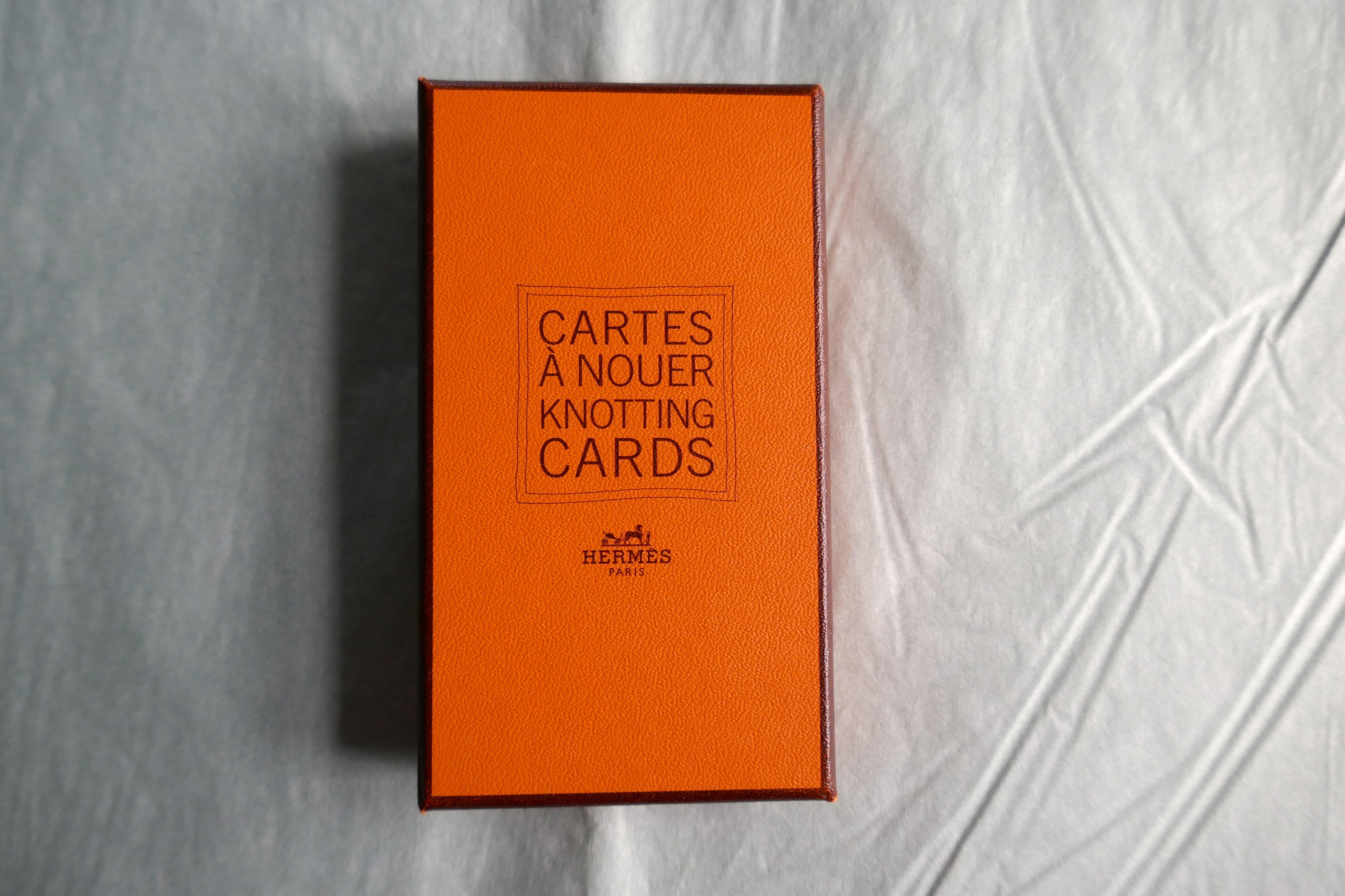 Hermès Knotting Cards in Original Orange Box!

Very interesting, it will show you how tie your scarves, in many funny possible ways!
A small gift for a fan of Hermès in new condition but has been opened. 

Authenticity Guaranteed
